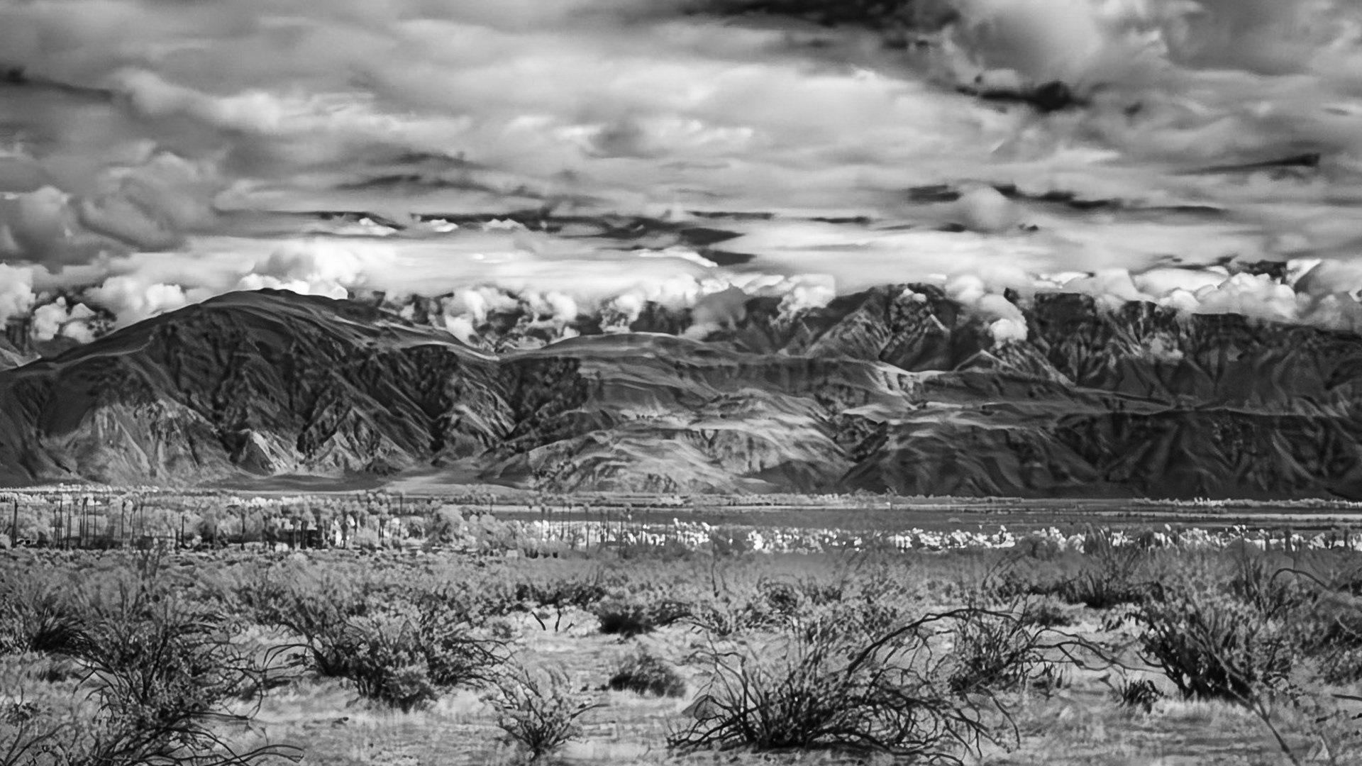 Gathering Clouds: Coyote Mountain in the foreground with clouds spilingl over the Santa Rosa Mountains into the Clark Valley that separates the two ranges.  An infra-red (720nm) image converted to Black-and-White.