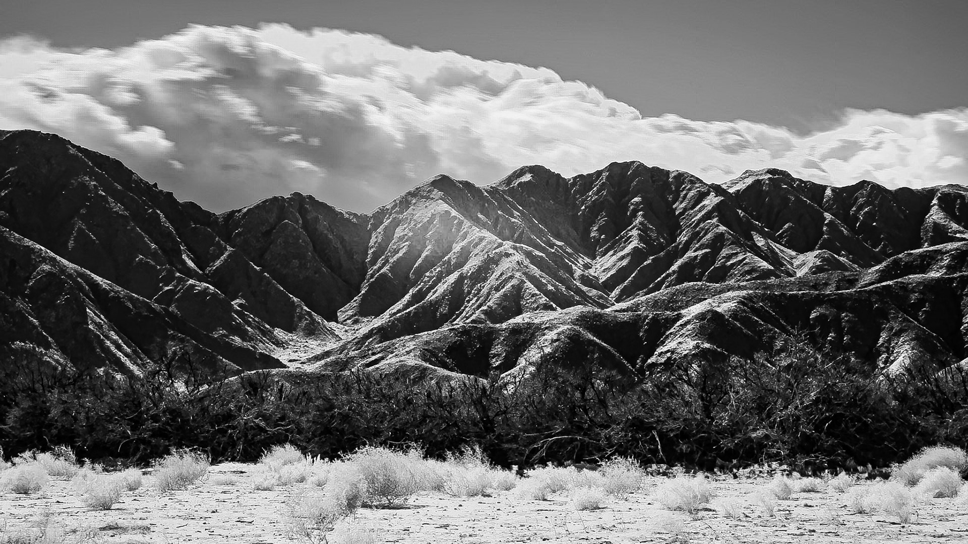 A weather system pushes clouds up the San Ysidro Mountains portending rain for a parched Anza-Borrego Desert.