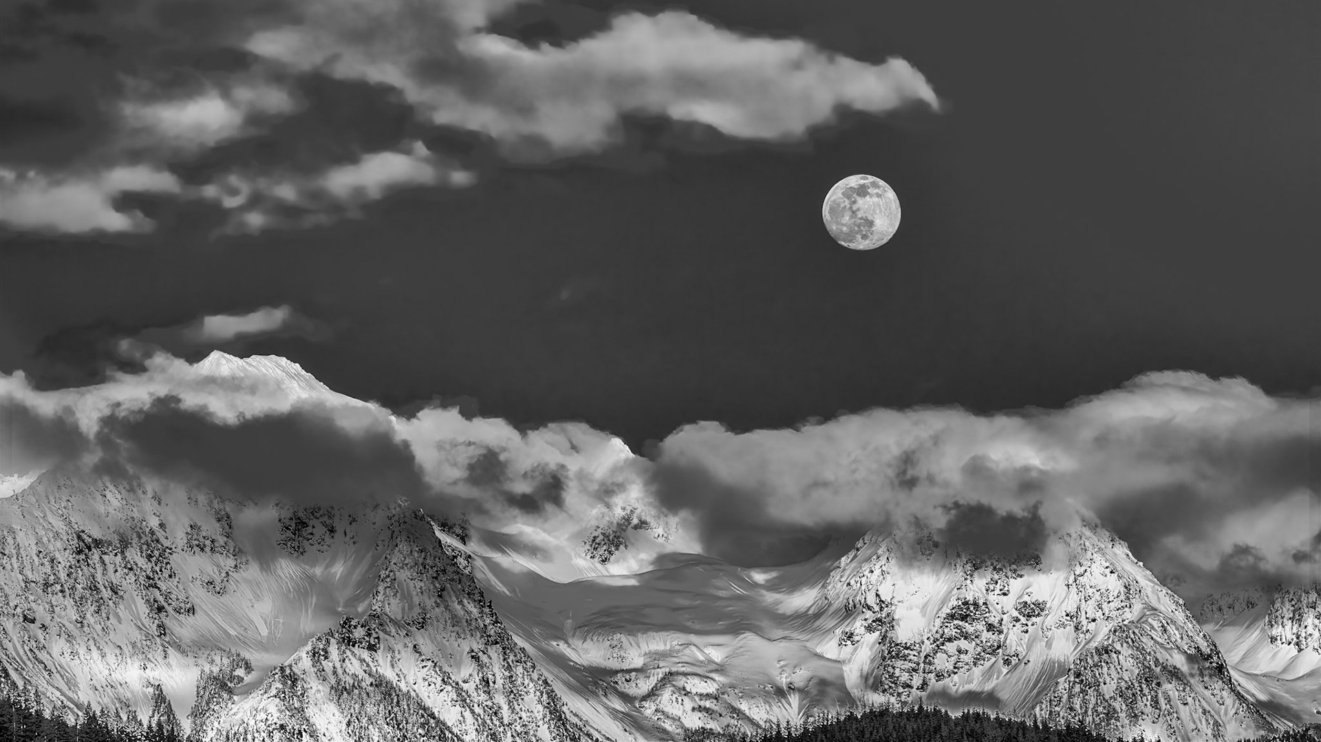 Cascade Moonrise Black-and-White: The clouds parted on an overcast day to reveal the moon rising above Twin Peaks near Mt. Baker in the Washington Cascades