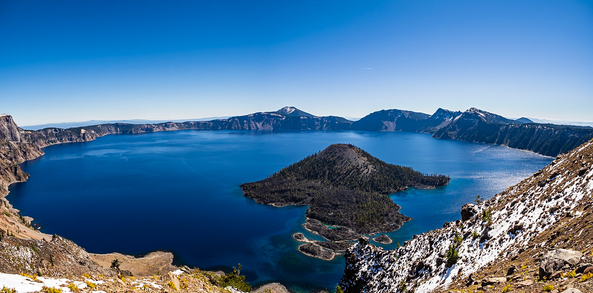 Crater Lake: A clear fall day at Crater Lake National Park provides a view across the 5-mile wide caldera of Mt. Mazama featuring Wizard Island in the foreground.