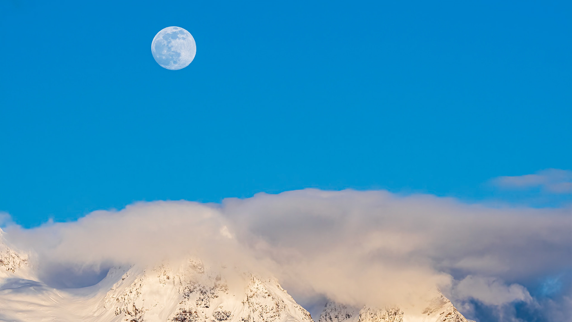 Blue Hour Moonrise: The clouds parted on an overcast day to reveal the moon rising above Twin Peaks near Mt. Baker in the Washington Cascades