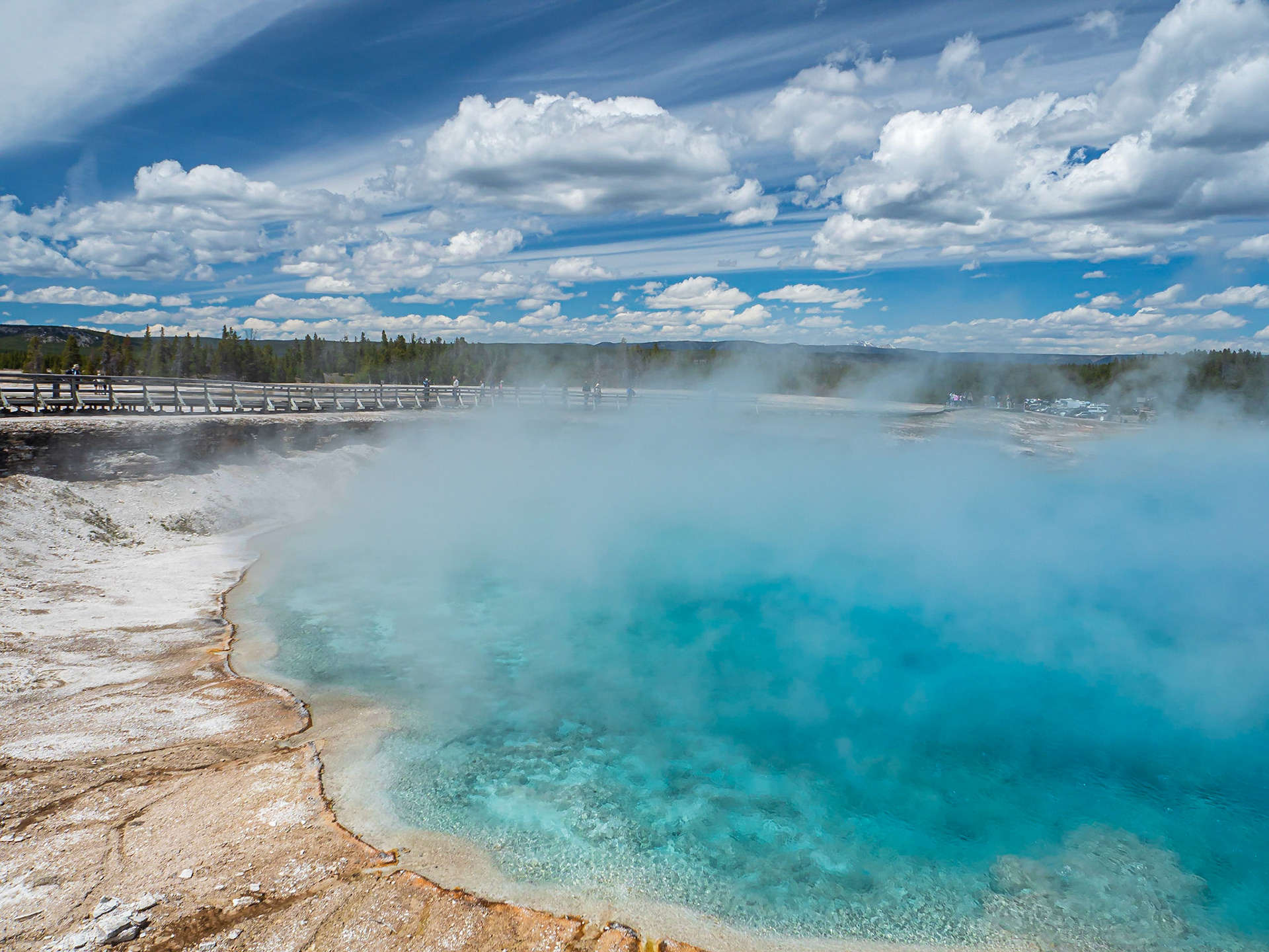 Grand Prismatic Hot Springs: Rising steam and brilliant blue waters are hallmarks of the Grand Prismatic Spring in  the Mid Geyser Basin of Yellowstone Natioinal Park.