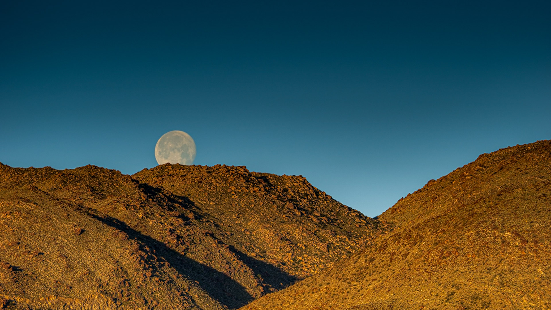 San Ysidro Moonset: Moonset behind the San Ysidro Mountians drenched in the cinnamon glow of dawn's early morning light.