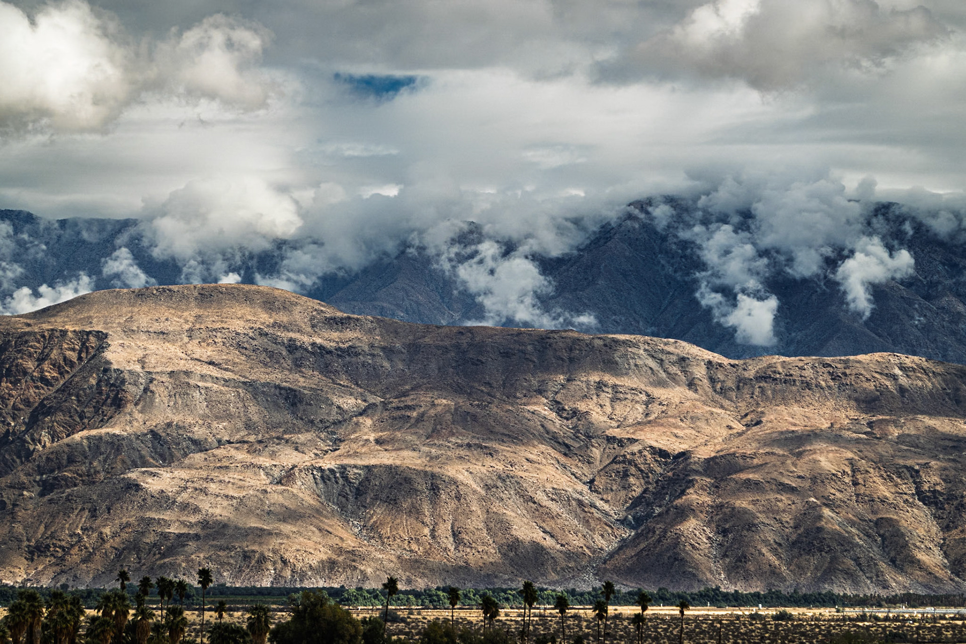 Santa Rosa Clouds: Coyote Mountain in the foreground with clouds spilingl over the Santa Rosa Mountains into the Clark Valley that separates the two ranges.