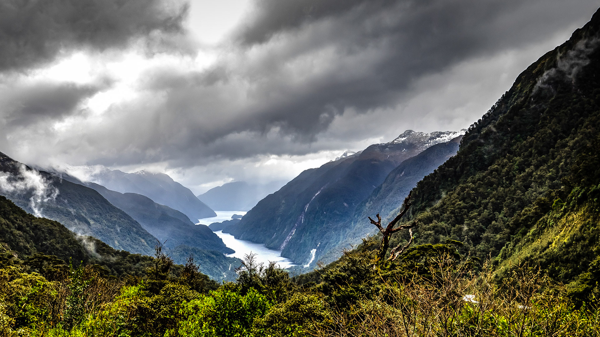 Rakituma - the Threatening Sky - Over Doubtful Sound NZ: Doubtful Sound on a stormy day,  flanked by snow-capped peaks and rain-driven cascades.  Viewed from the Wilmot Pass Road.