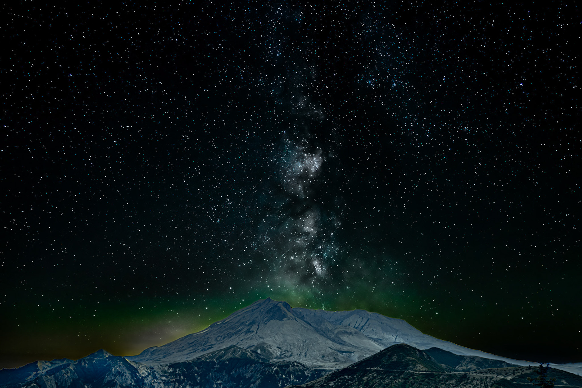 Starry Eruption Over Mt. St. Helens: The Milky Way seems to erupt from Mt. St. Helens on the eve of the new moon in late August.  Light pollution emanating from Portland OR and Vancouver WA glows over the left flank of the mountain.  The image is a composite of a foreground exposure taken at dusk and a starry sky exposure taken just before midnight.