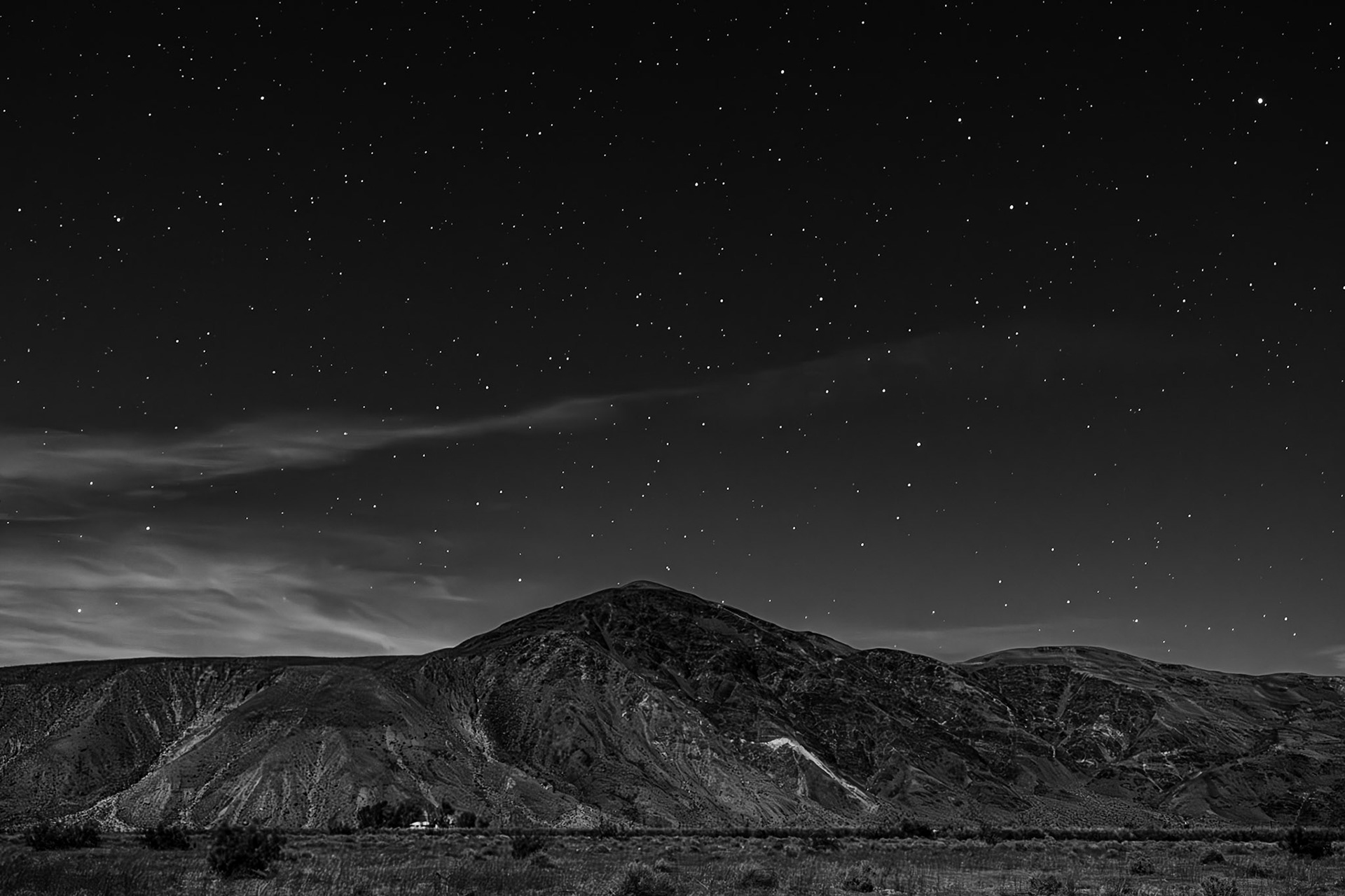 Homestead Under Moonlight Black-and-White: A waxing gibbous moon illuminates Coyote Mountain and a desert homestead near the entrance to Coyote Canyon in the Anza-Borrego Desert State Park.