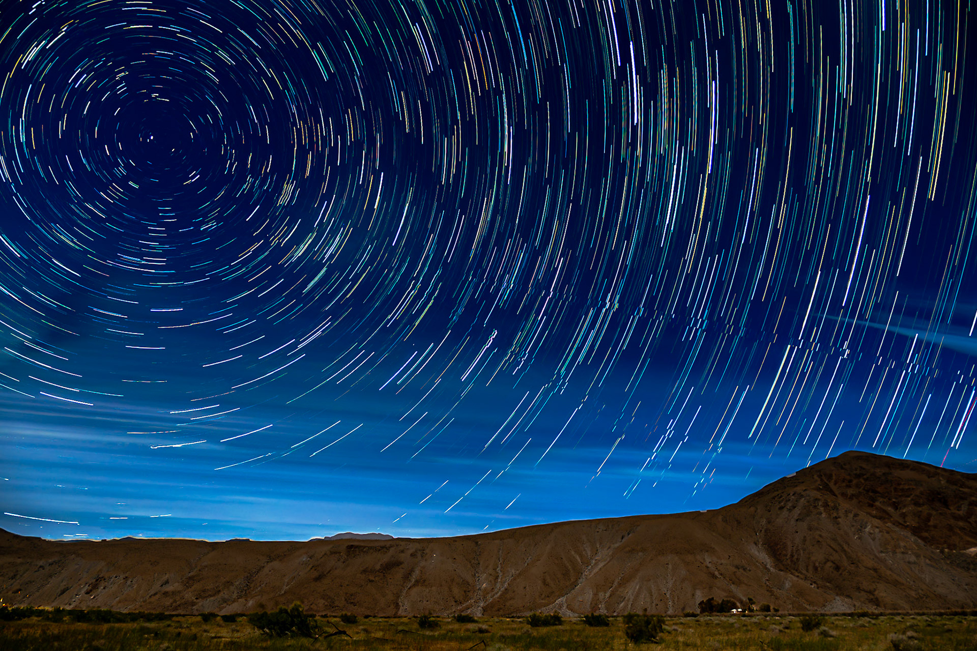 Borrego Valley Startrails: Startrails swirl over a solitary Borrego-Valley farmhouse seen at the foot of Coyote Peak on a soft moonlit night.