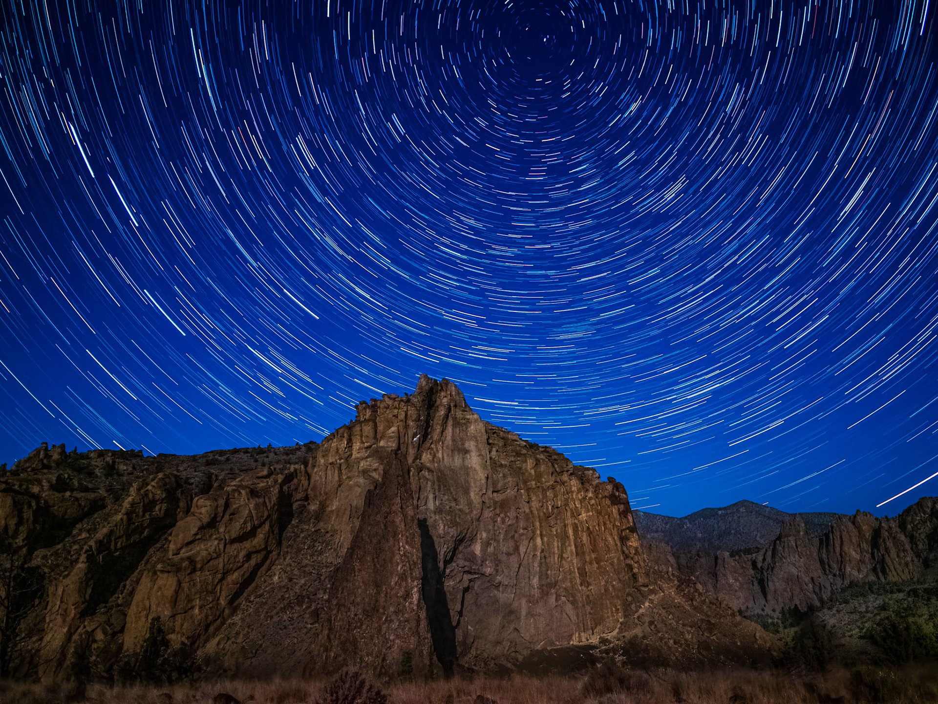 Starry Night at Smith Rock: A gibbous moon provided faint light to illuminate Smith Rock at night.  A long exposure sequence captured Polaris and star trails rotating above the peak.