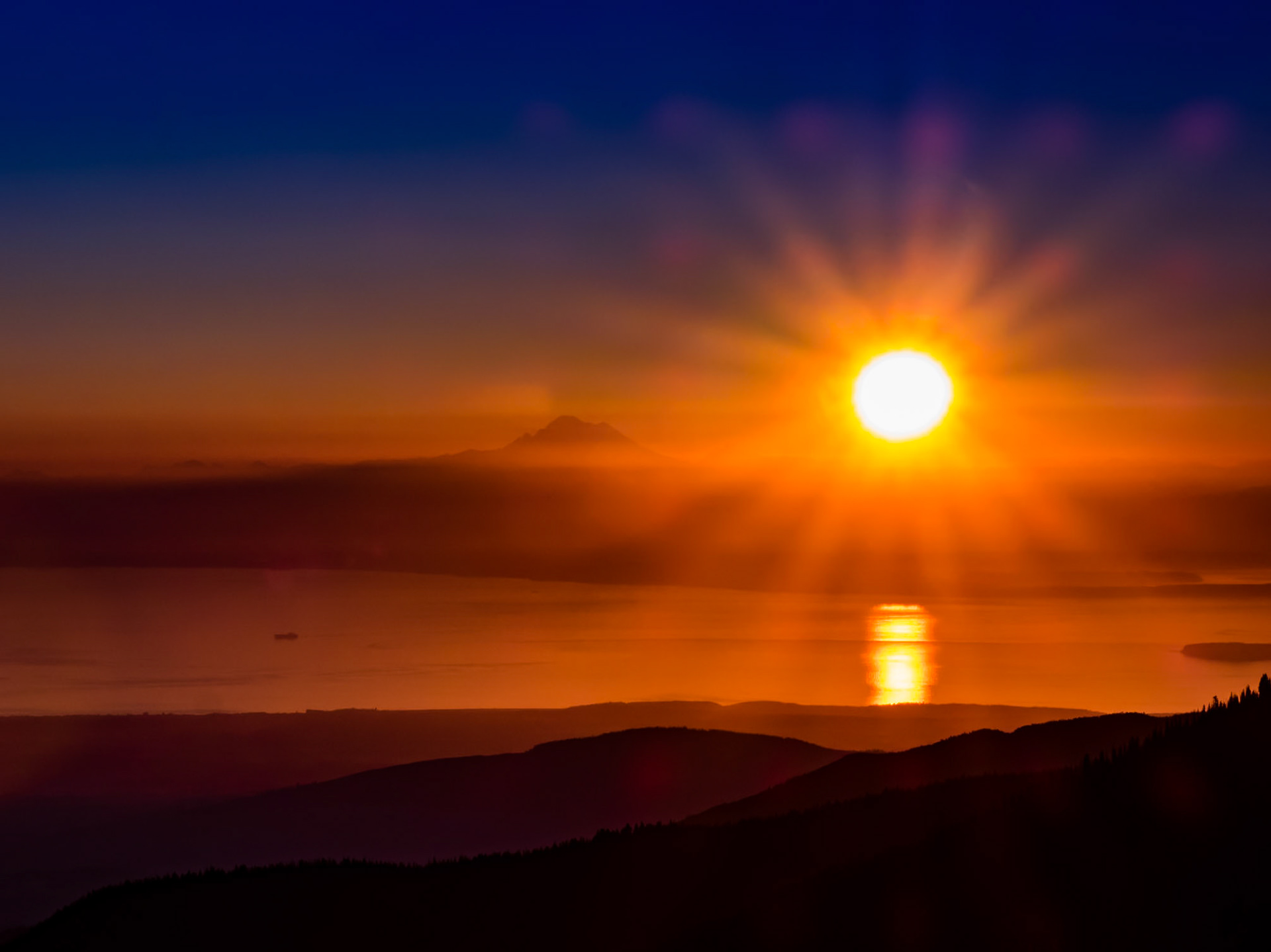 Sunrise: Over Mt. Baker, the Eastern Straits of Juan de Fuca and the foothills of the Olympic Mountains.