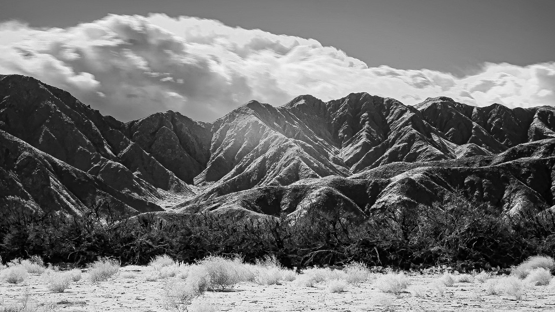 A weather system pushes clouds up the San Ysidro Mountains portending rain for a parched Anza-Borrego Desert. An infra-red (720nm) image converted to Black-and-White.