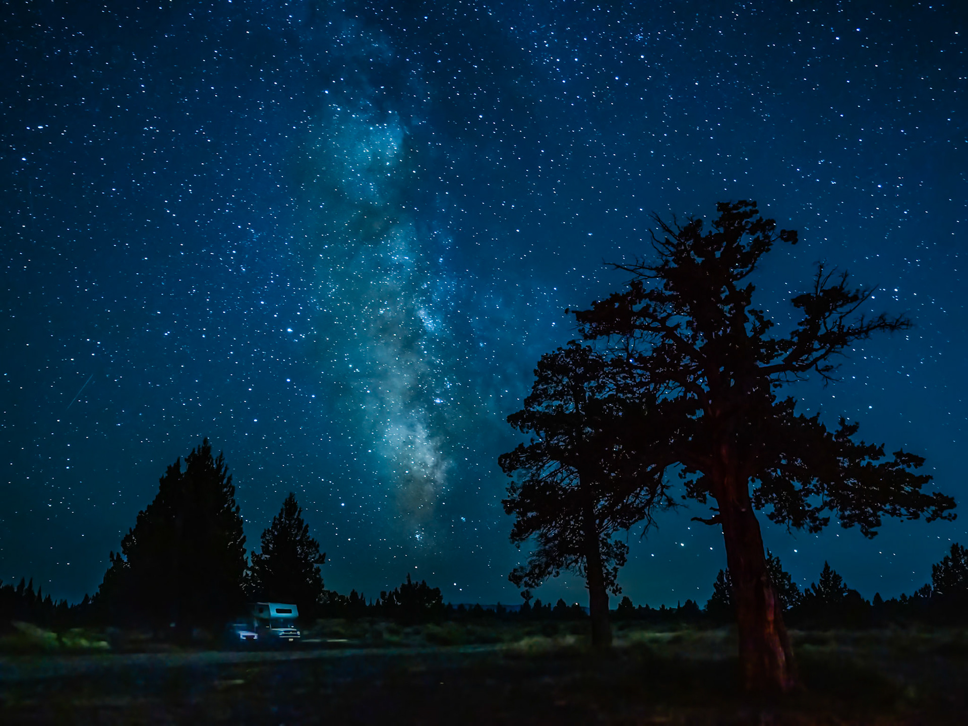 High Desert Milkyway: The Milky Way gives faint illumination to campers on a moonless evening near Bend Oregon.