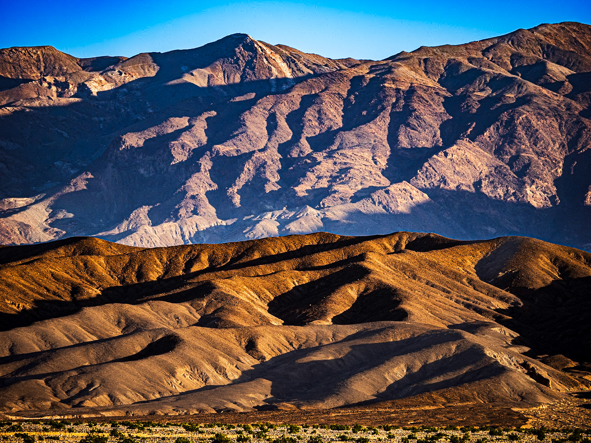 Funeral Mountains: In early morning light, the Funeral Mountians rise from Death Valley  with steep ridges and deeply shadowed ravines.