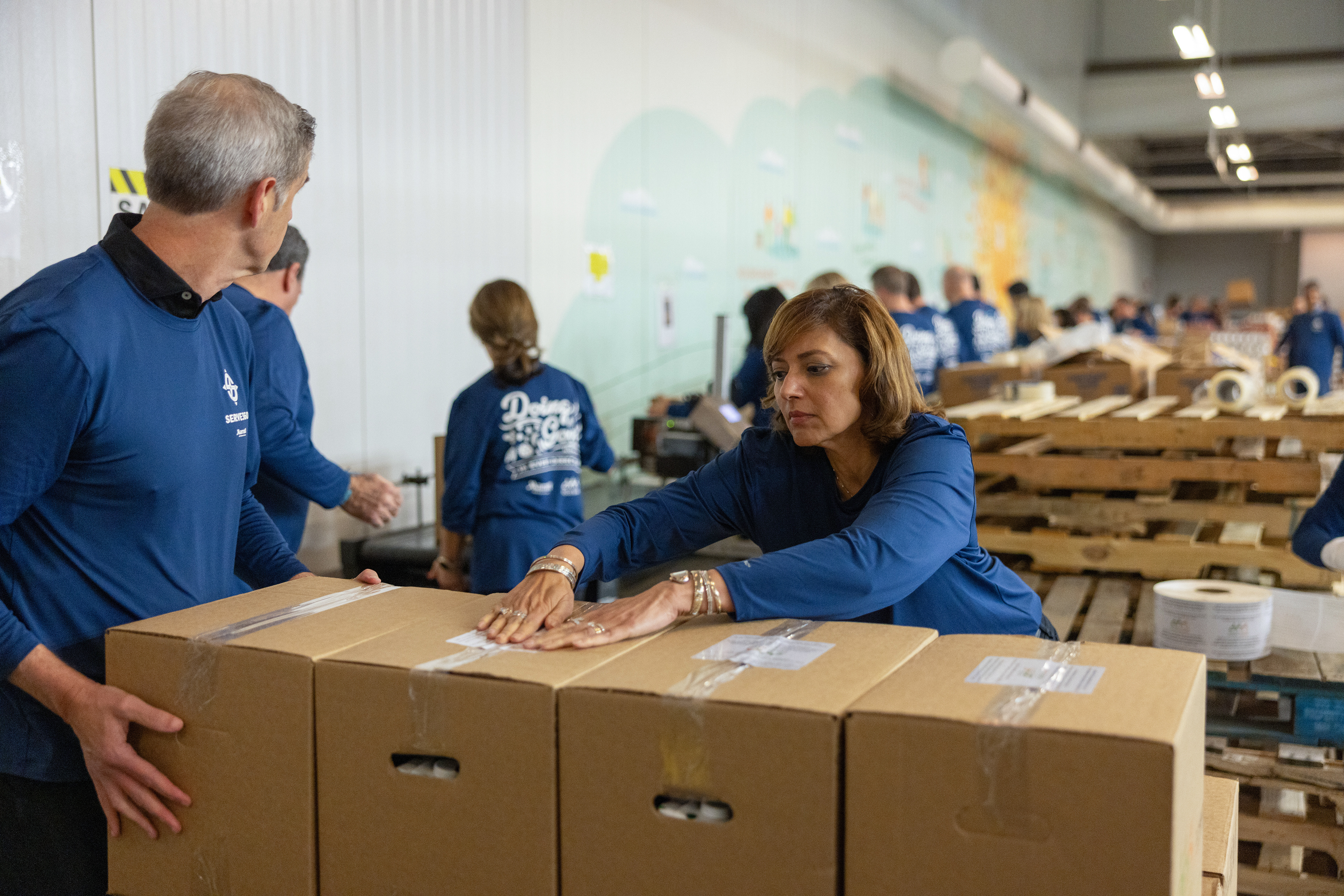 Tina Edmundson, President of Luxury, packages food for distribution