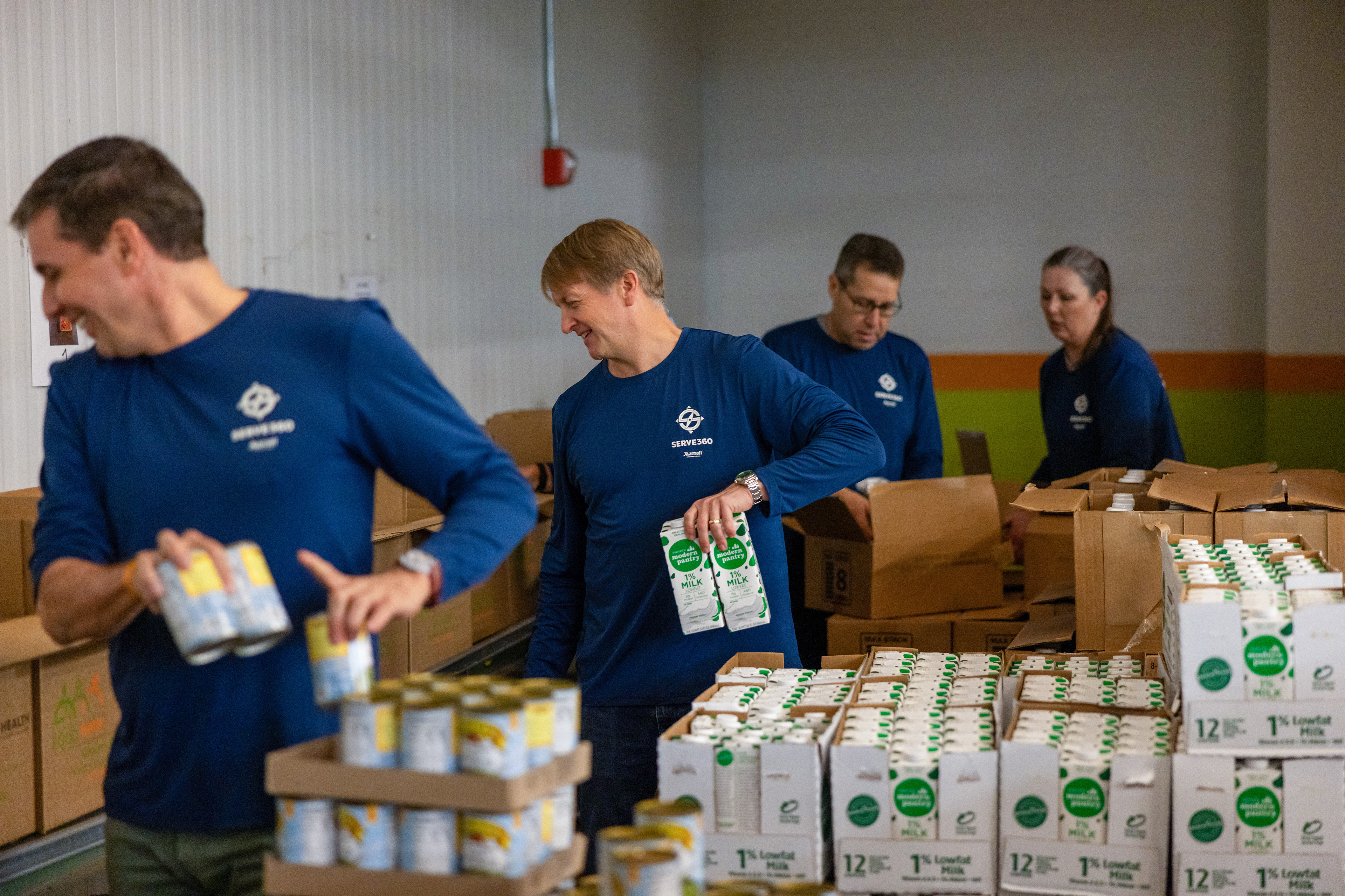 David Marriott, Chairman of the Board, packages food for distribution