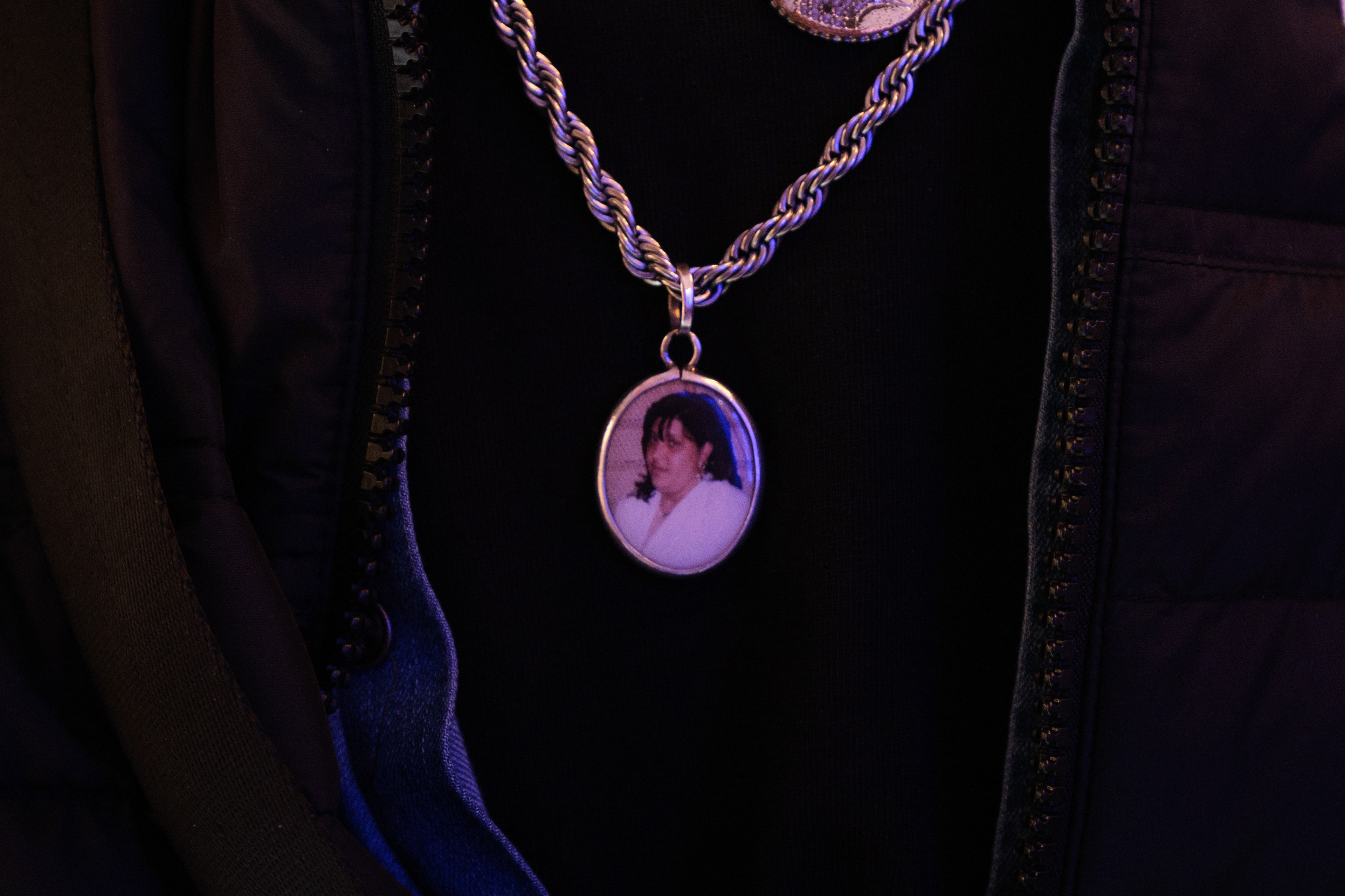 Naples (Italy): A close-up of a pendant worn by local resident Vincenzo Ziccardi, featuring a portrait of his late wife, Maria. Her passing inspired him to transform a small sanctuary that eventually grew into a collective memorial for the Rione Sanità neighborhood.