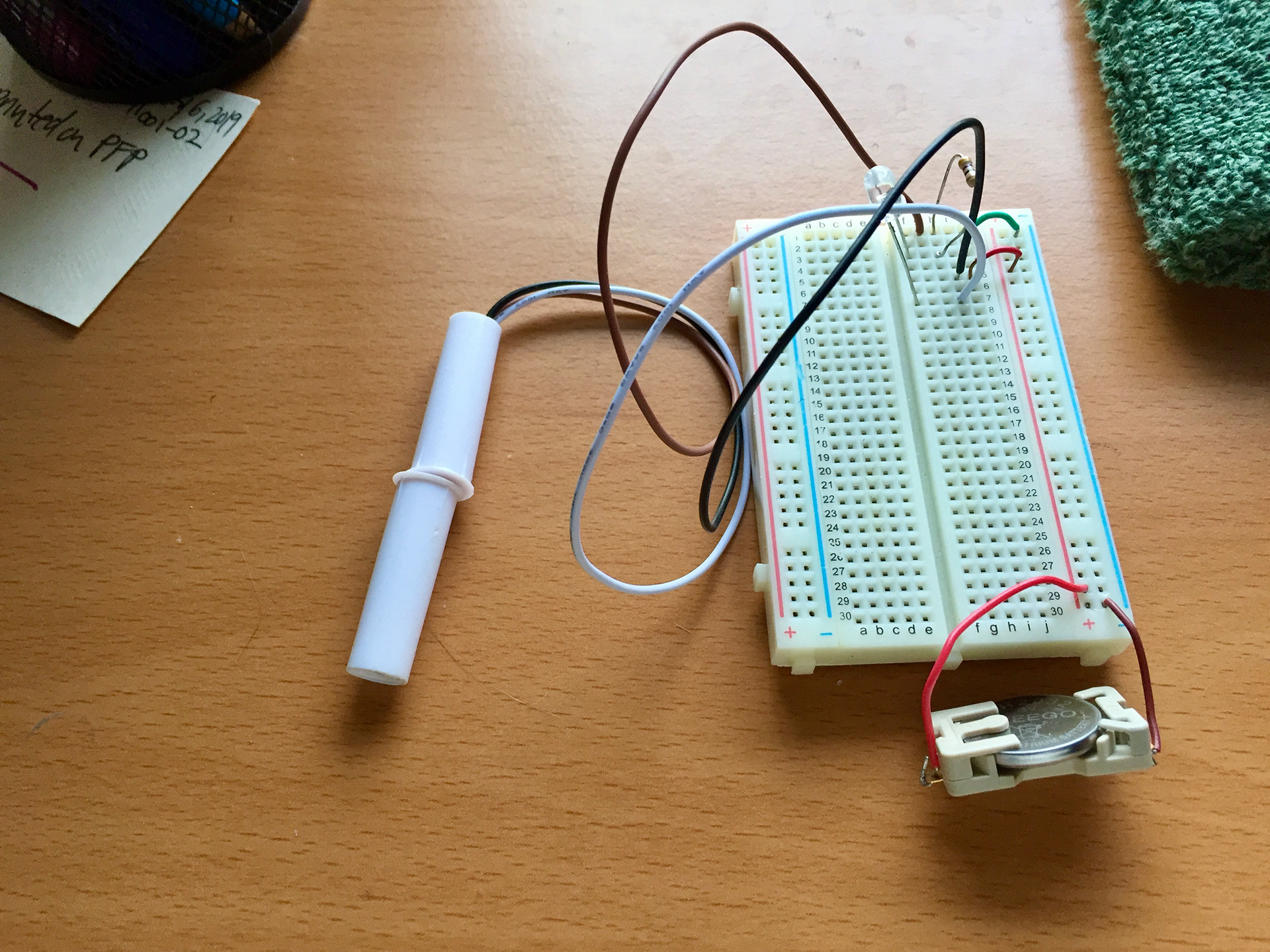 Magnetic switch for LED - switch lives next to snap fastener so it turns off when closed and on when open.