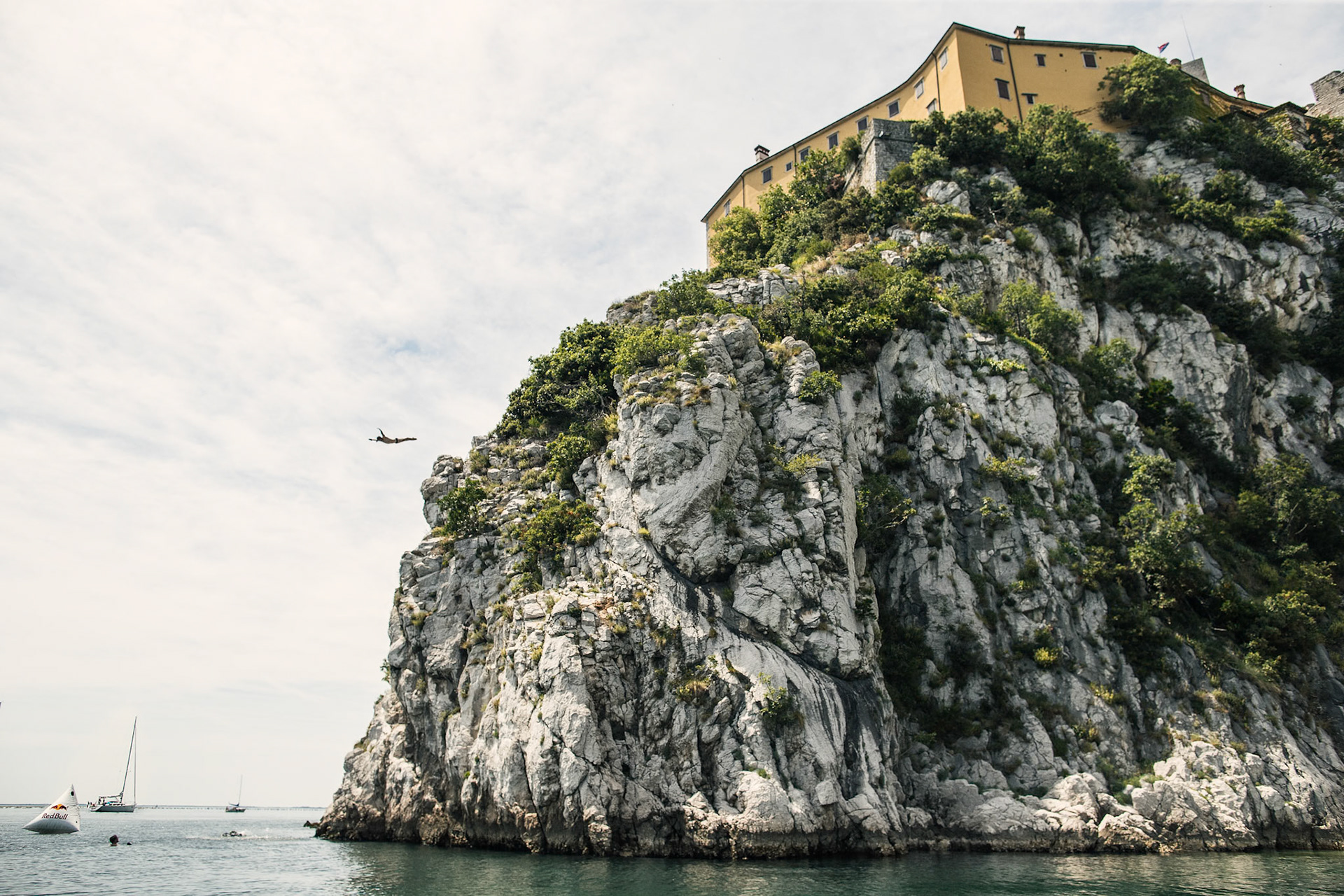 Alessandro De Rose of Italy dives from the cliff under the Castello di Duino during the Road To Cliff Diving Italy in Trieste, Italy on June 10, 2017.