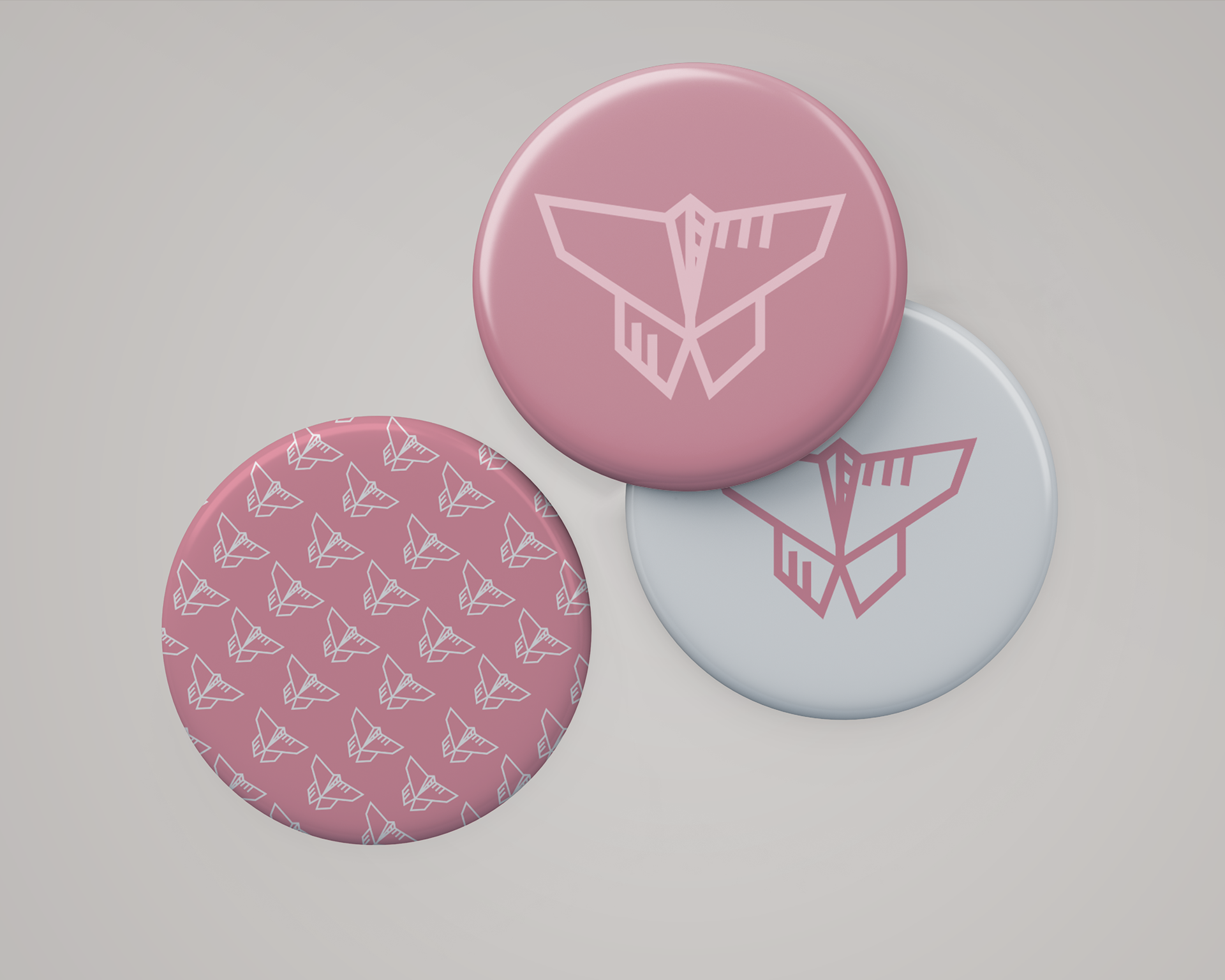 The pins are designed in individual styles: one with the pattern, one dusty pink with a tinted pink logotype, and a color symbol over a white background.