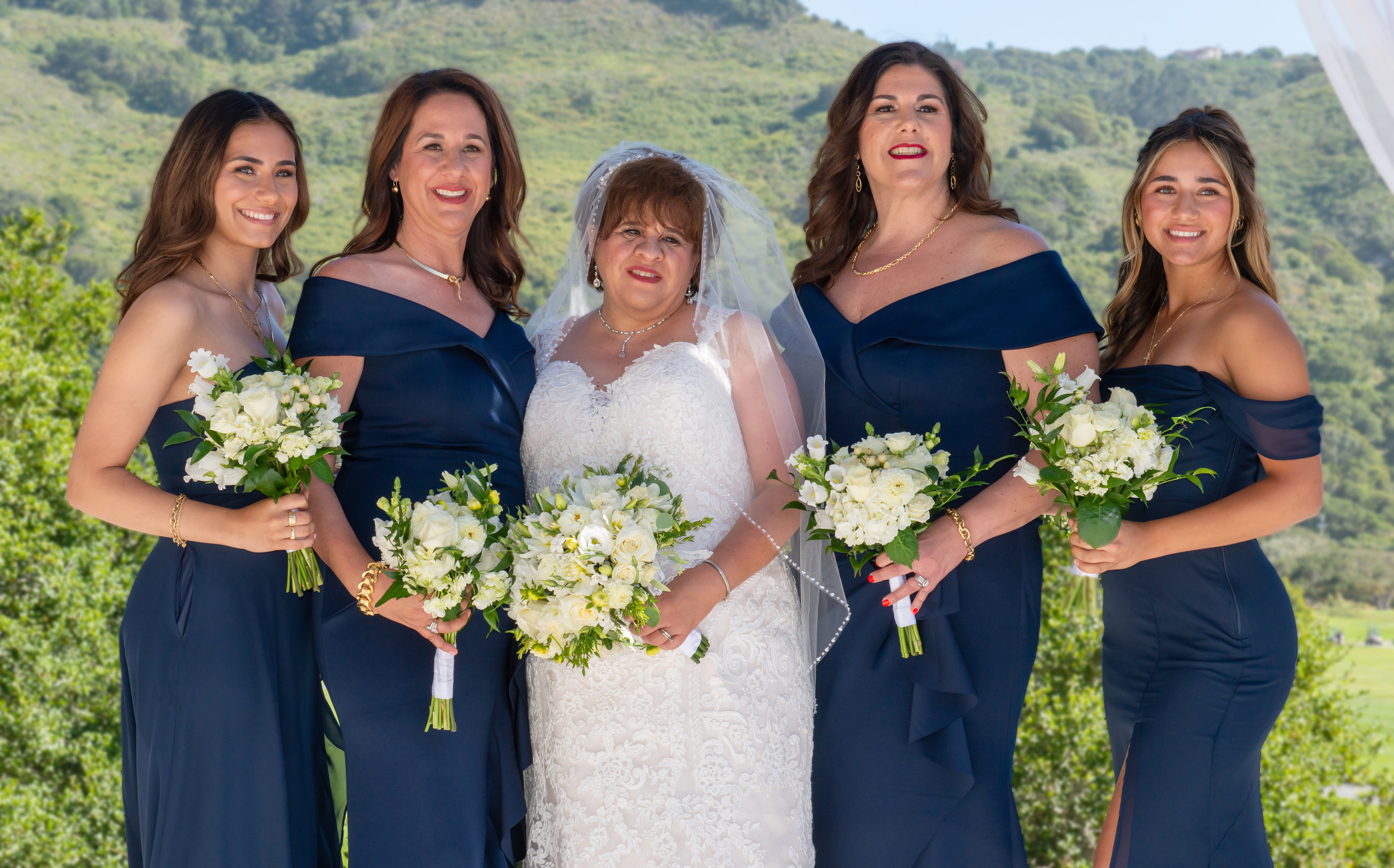 Bride poses with her bridesmaids on the altar at Fairview Laguna Seca
