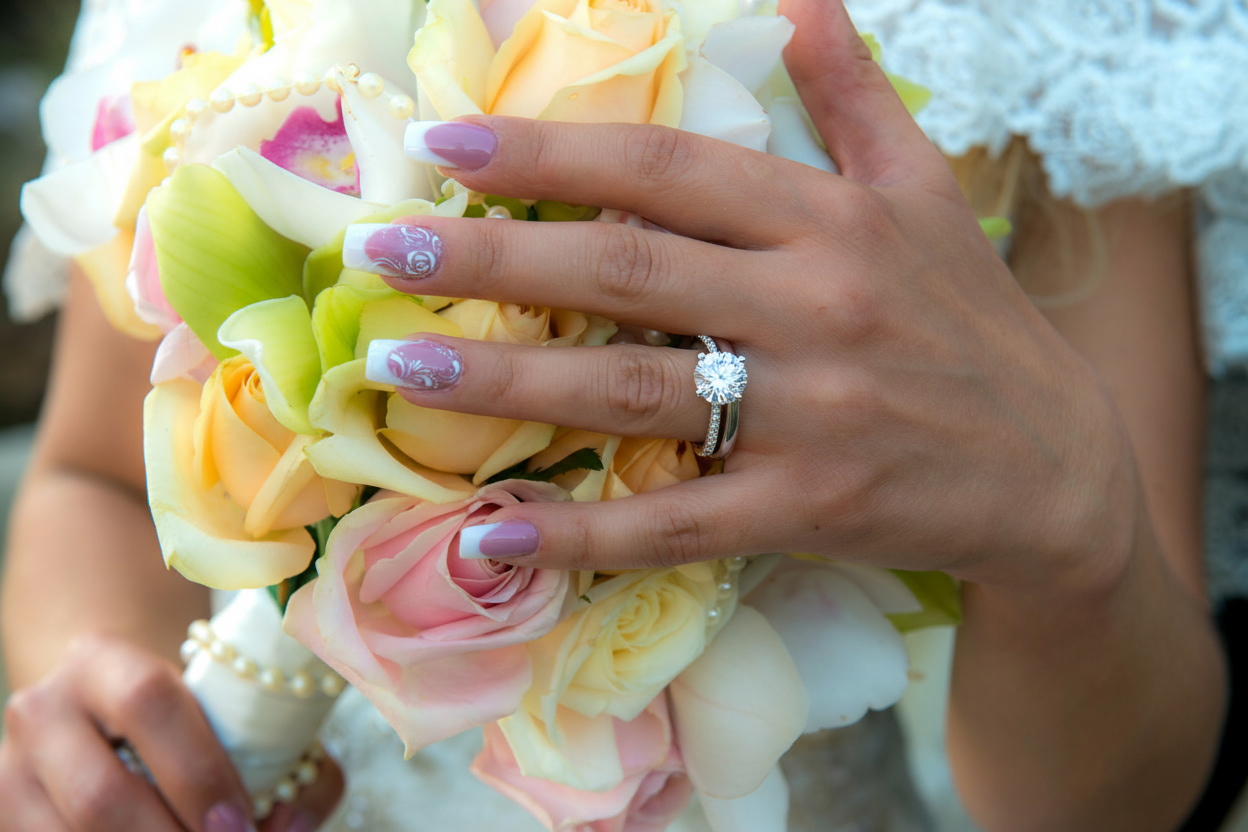 Bride and groom hands with wedding rings Monterey Photography