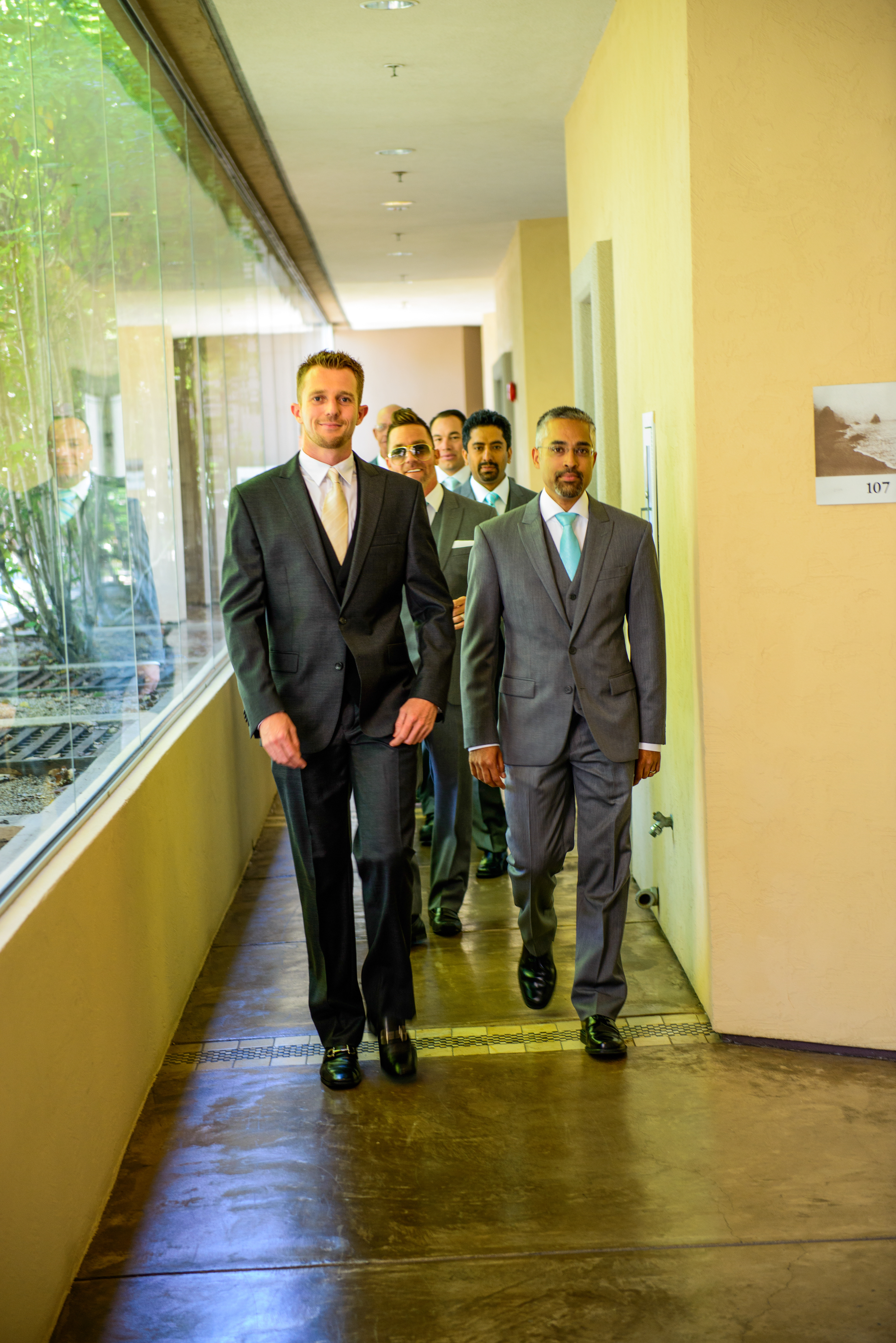Hotel suite groom prep with groomsmen raising a toast