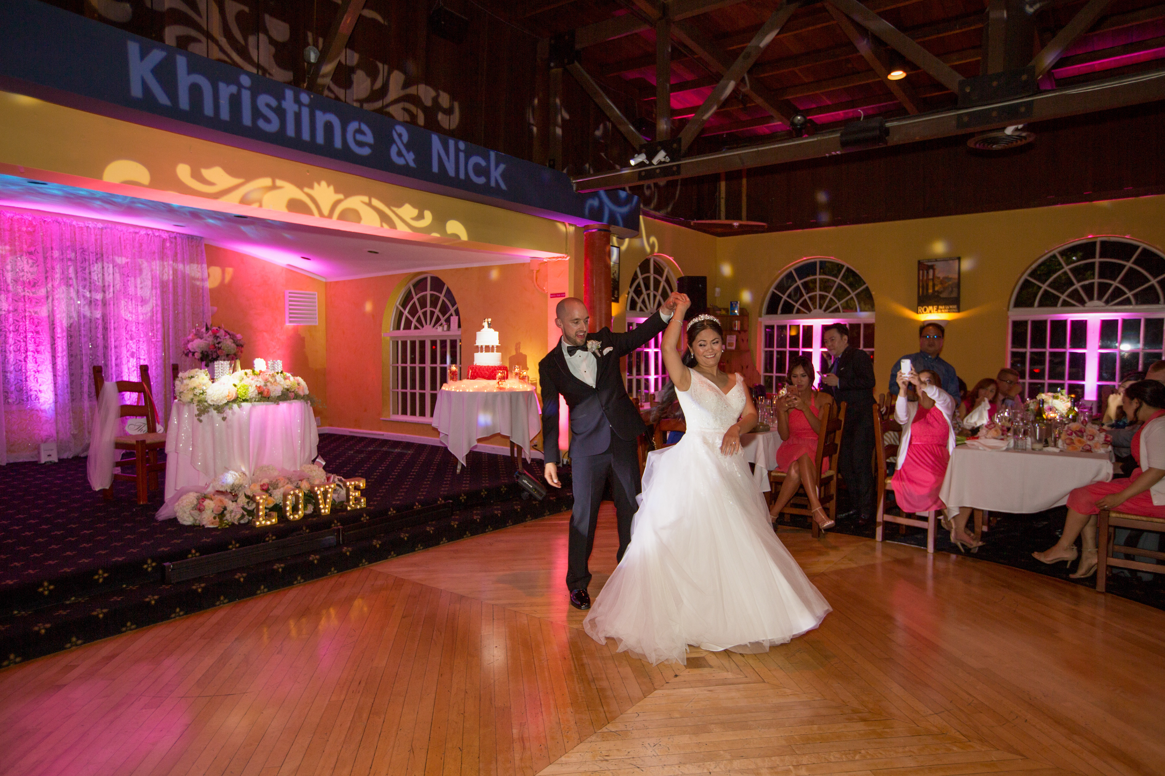 Reception first dance at Mezza Luna by the Sea with crowd energy in background
