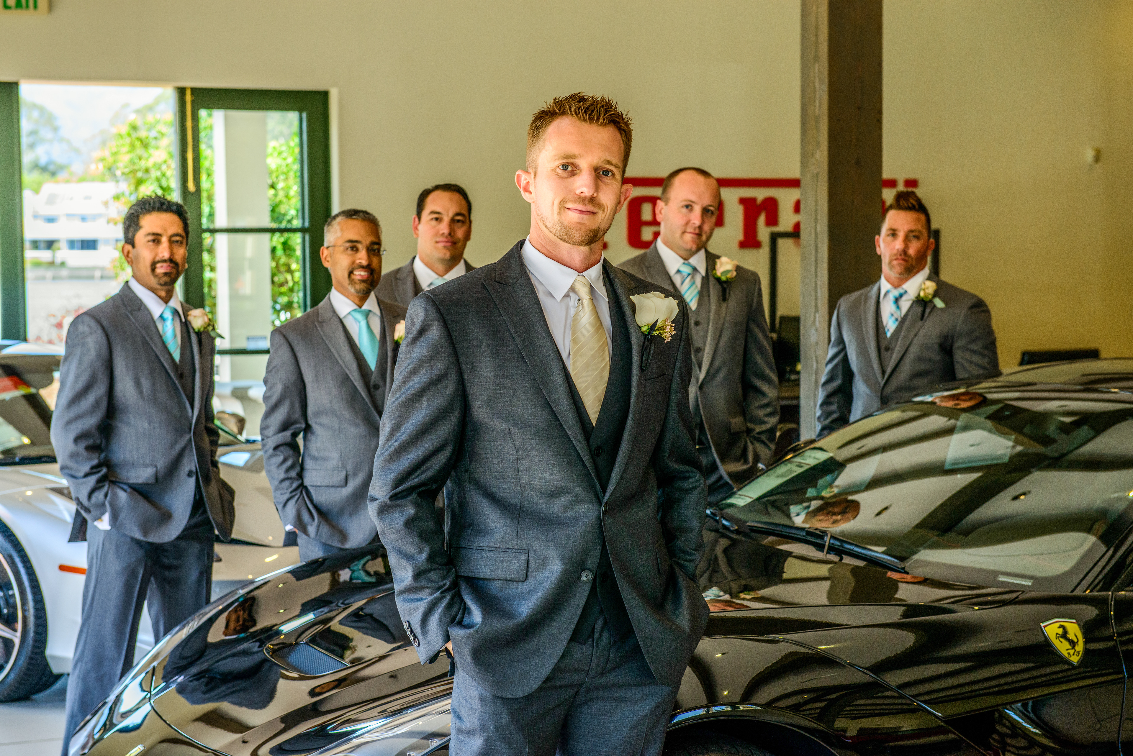 Candid laughter of groom and groomsmen during wedding preparations