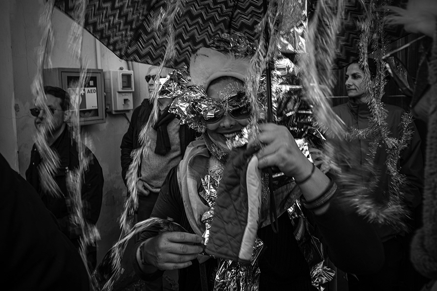 A woman in the crowded parade at the Mostra Festival. Chios in Greece,2024