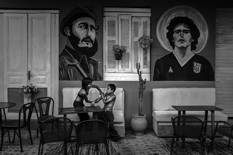 The island of Lesbos is one of the islands with the highest number of refugees. This island, which is very close to Turkey, is generally located on the migration route of refugees. For this reason, it is possible to see refugees begging on the streets of the island.The two childs in the photo just asked for money and then started joking around in front of Cubano Bar    Lesvos in Greece,2024