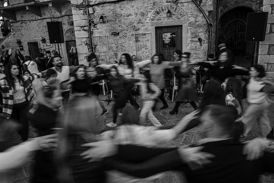 Villagers having fun and dancing in the medieval village of Mesta.Mostra Carnival is held on the island on these dates.  Chios in Greece,2024