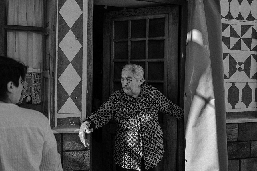 An old woman leaves her house   Chios in Greece ,2023