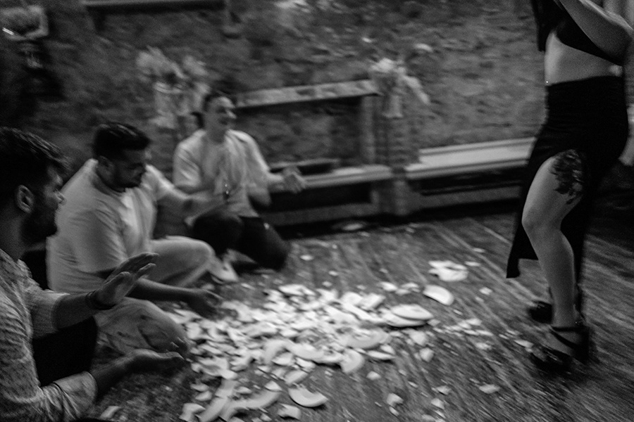 A woman dancing in a classic Greek tavern. Traditionally, plates are broken and men kneel in front of her, keeping rhythm . Chios in Greece,2023