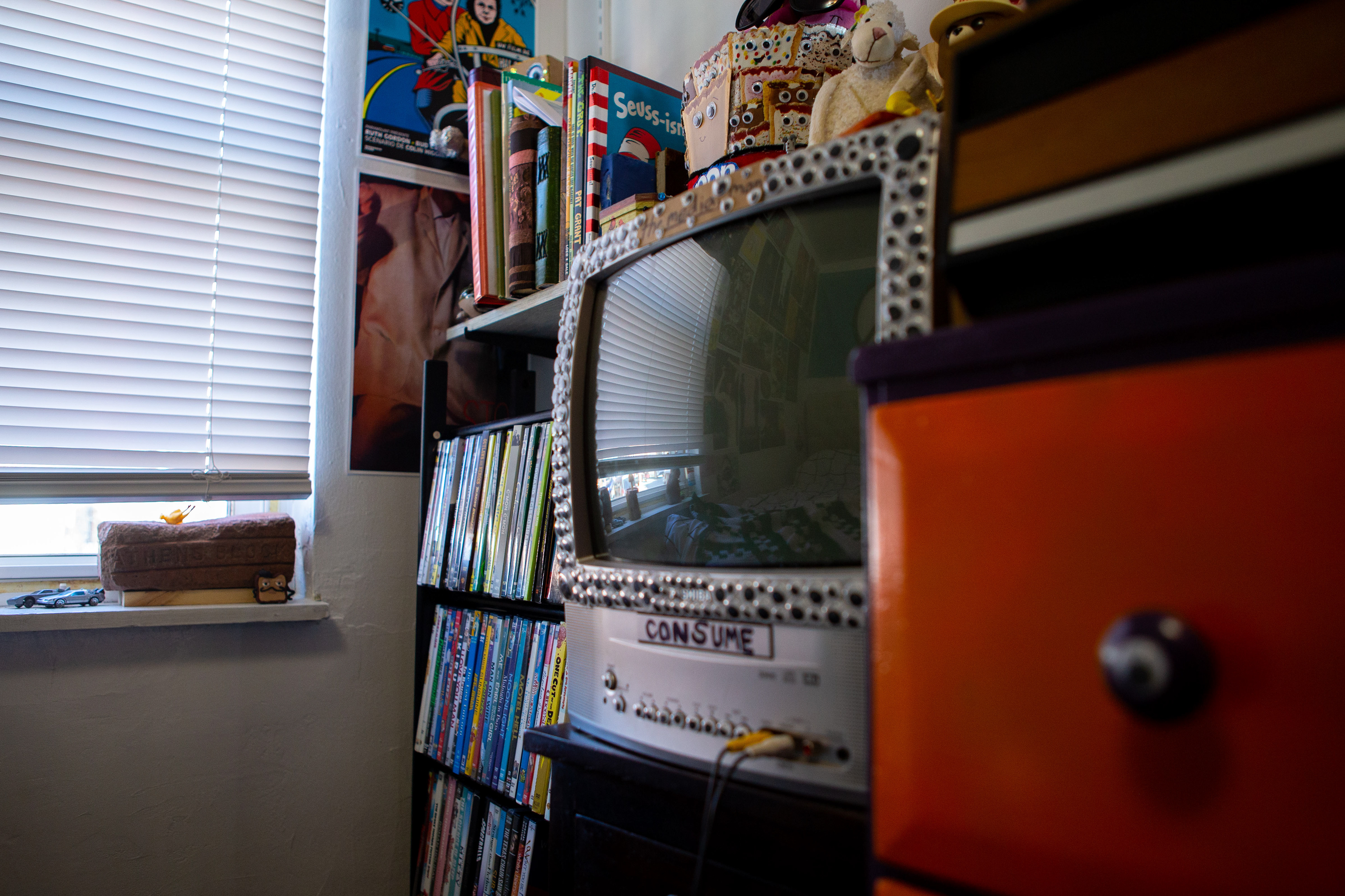 A television is filled with googly eyes. Brandes enjoys placing eyes on different objects around his household.