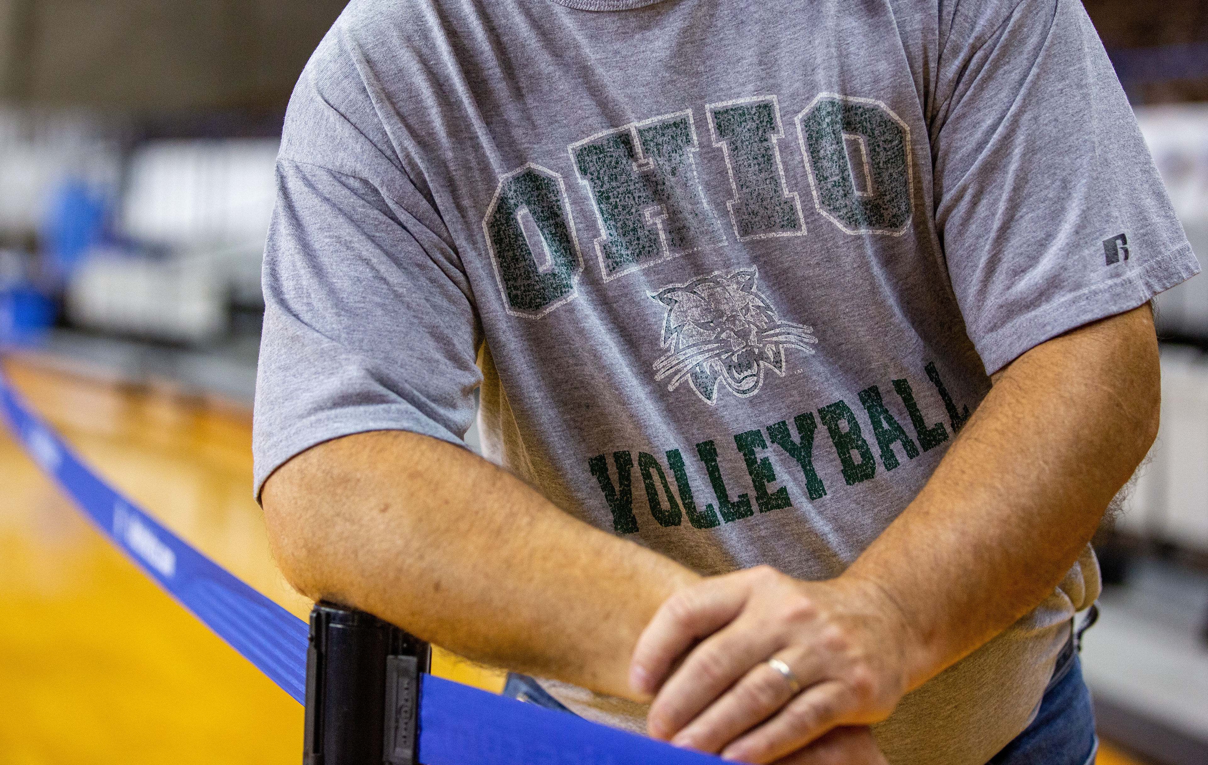 An Ohio University dad watches his daughter warm up before her game against the University of Kentucky. The dad states, “I have traveled to every away game to watch my daughter, even to Hawaii!”