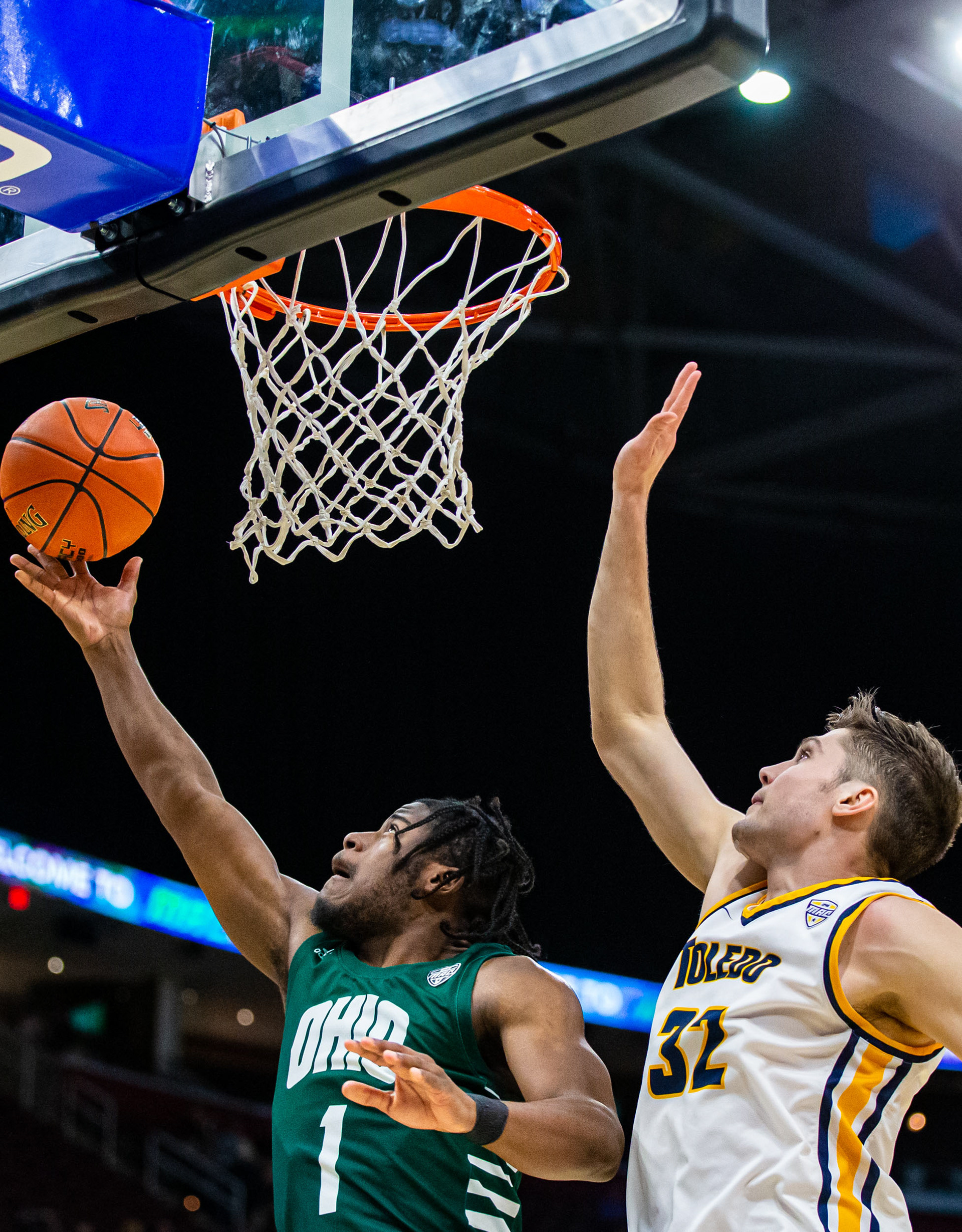 Ohio Guard Elmore James goes in for a layup while being guarded by Toledo Forward JT Shumate during the MAC Tournament in Cleveland, Ohio.