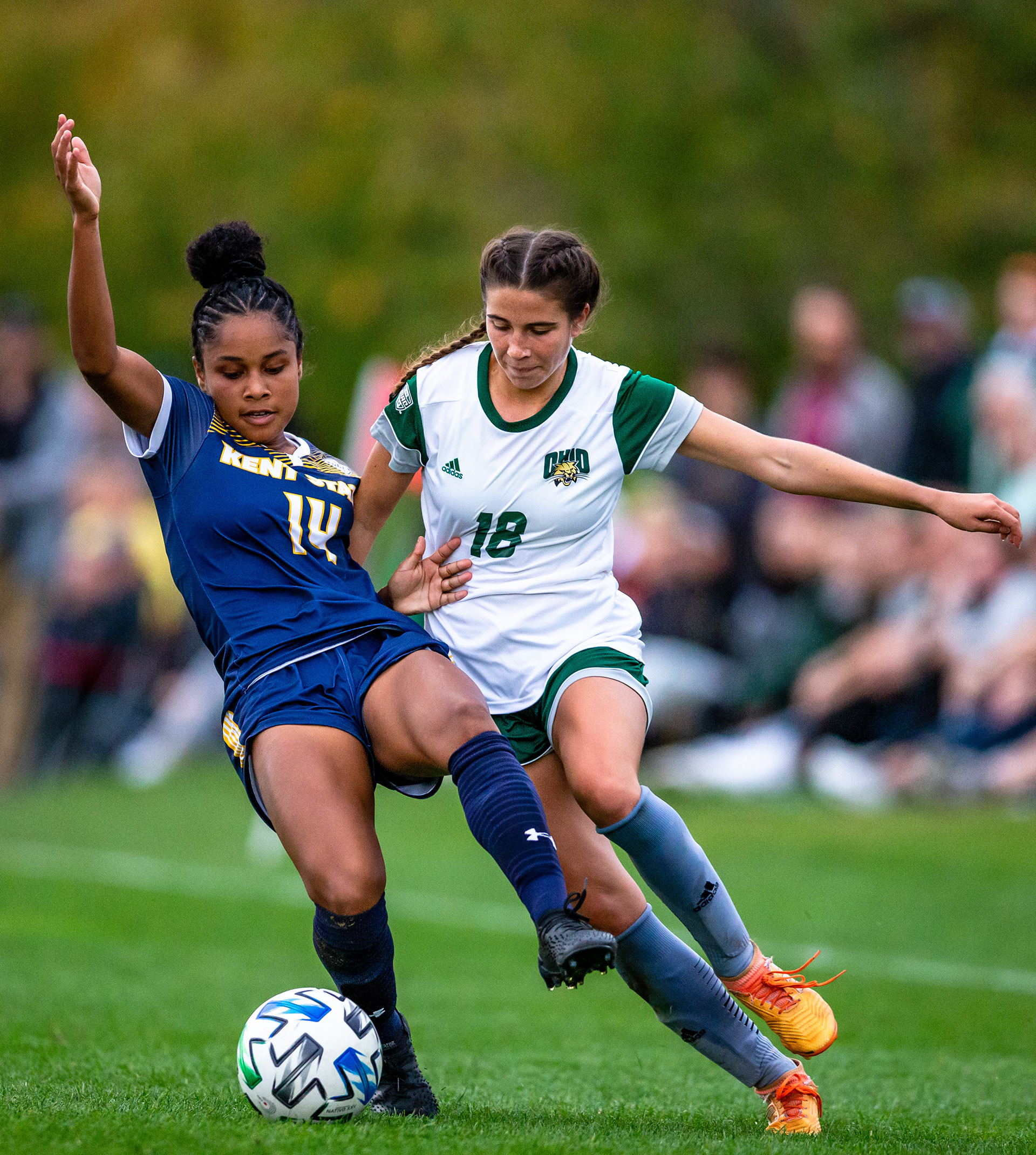 Ohio Forward Shae Robertson tackles Kent State Defender Lizzie Philibin in Athens, Ohio.