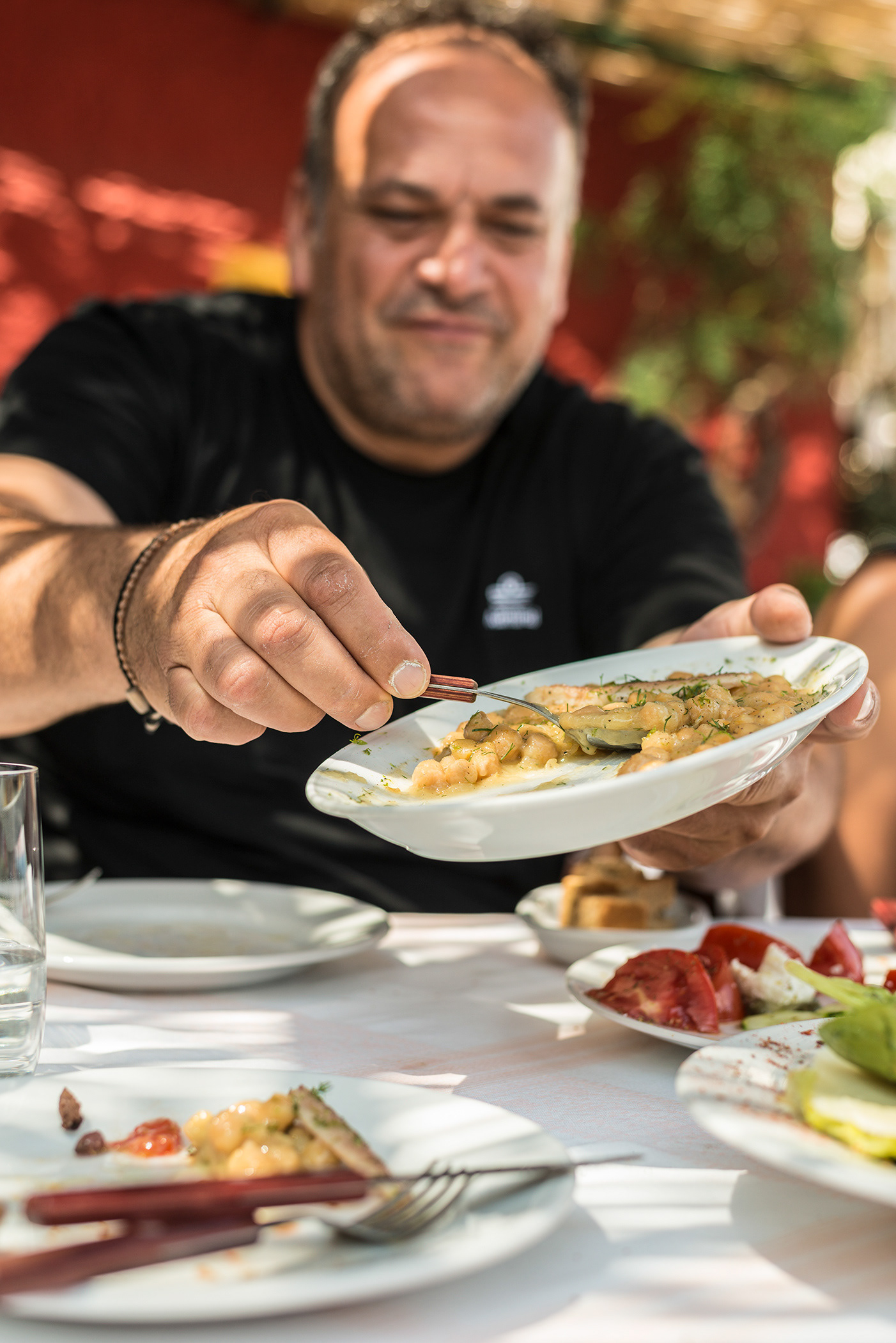 Owner and host Kostas Chryssocherakis seves us lunch at the lovely Metaxy Mas restaurant - Exo Gonia