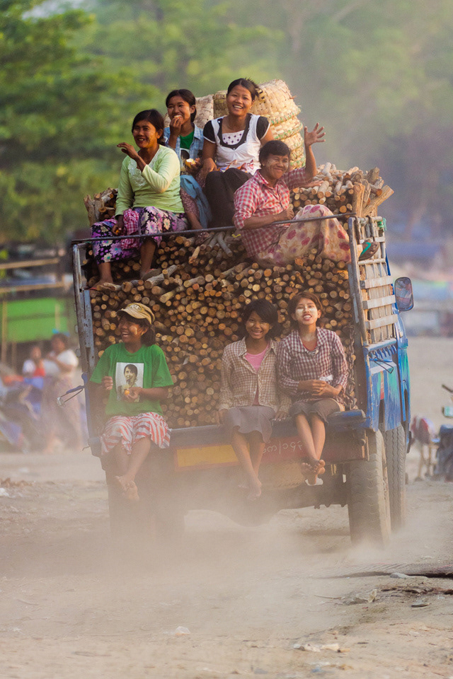Workers hitch a lift home along the Irrewaddy River, Mandelay