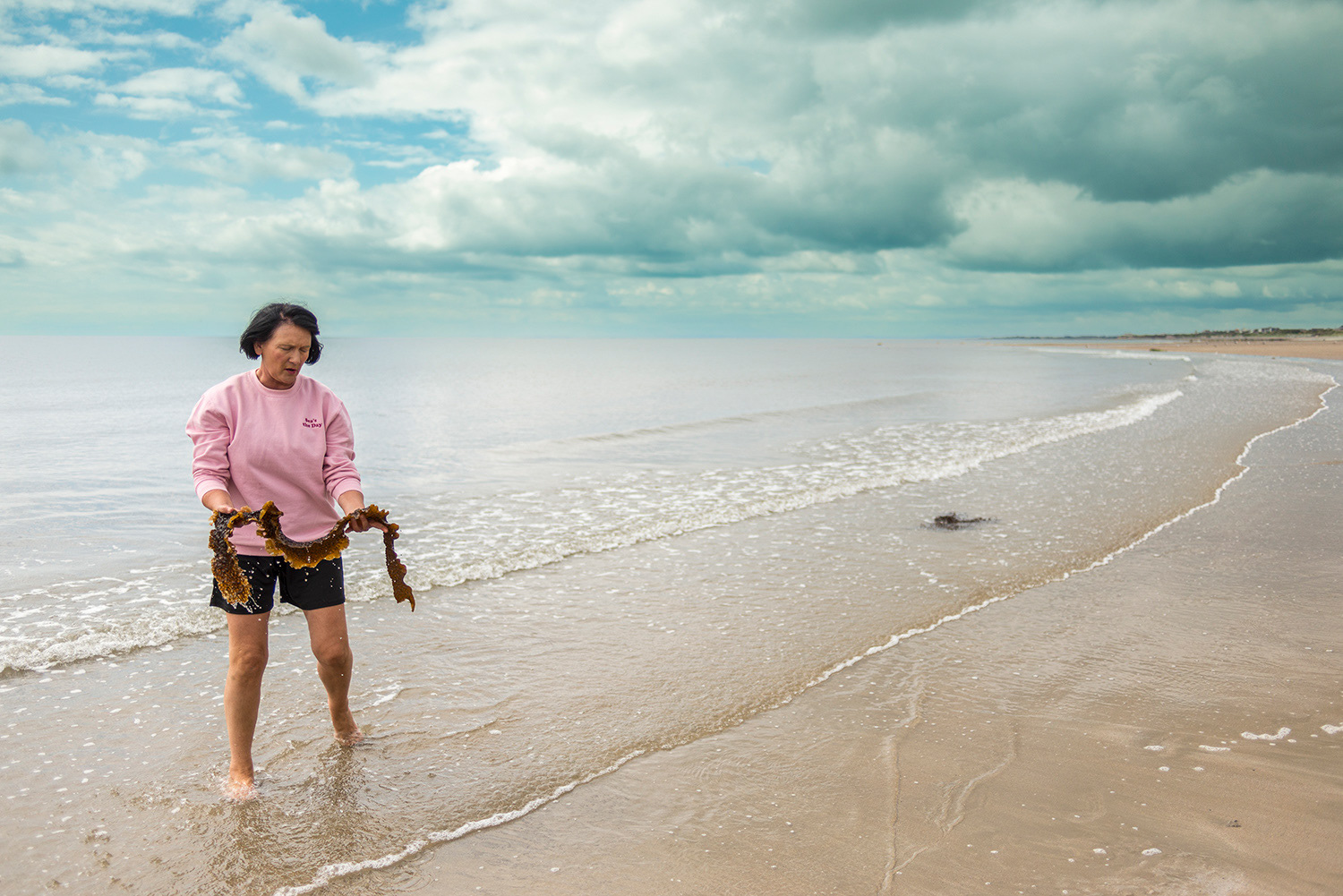 Michelle Wilson of Crawfords Rock Seaweed Salt harvesting kelp used in seaweed baths - Kilkeel Bay