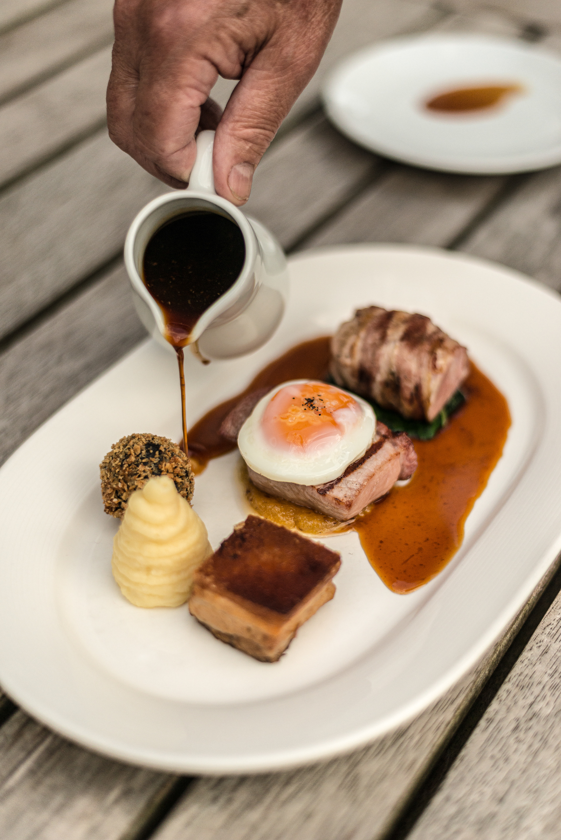 Piggy Grill (Gammon Ribeye, fried duck egg, pork fillet, Streaky Bacon, pineapple and whole grain-mustard ketchup) served at the The Assherton Arms in Downham Village