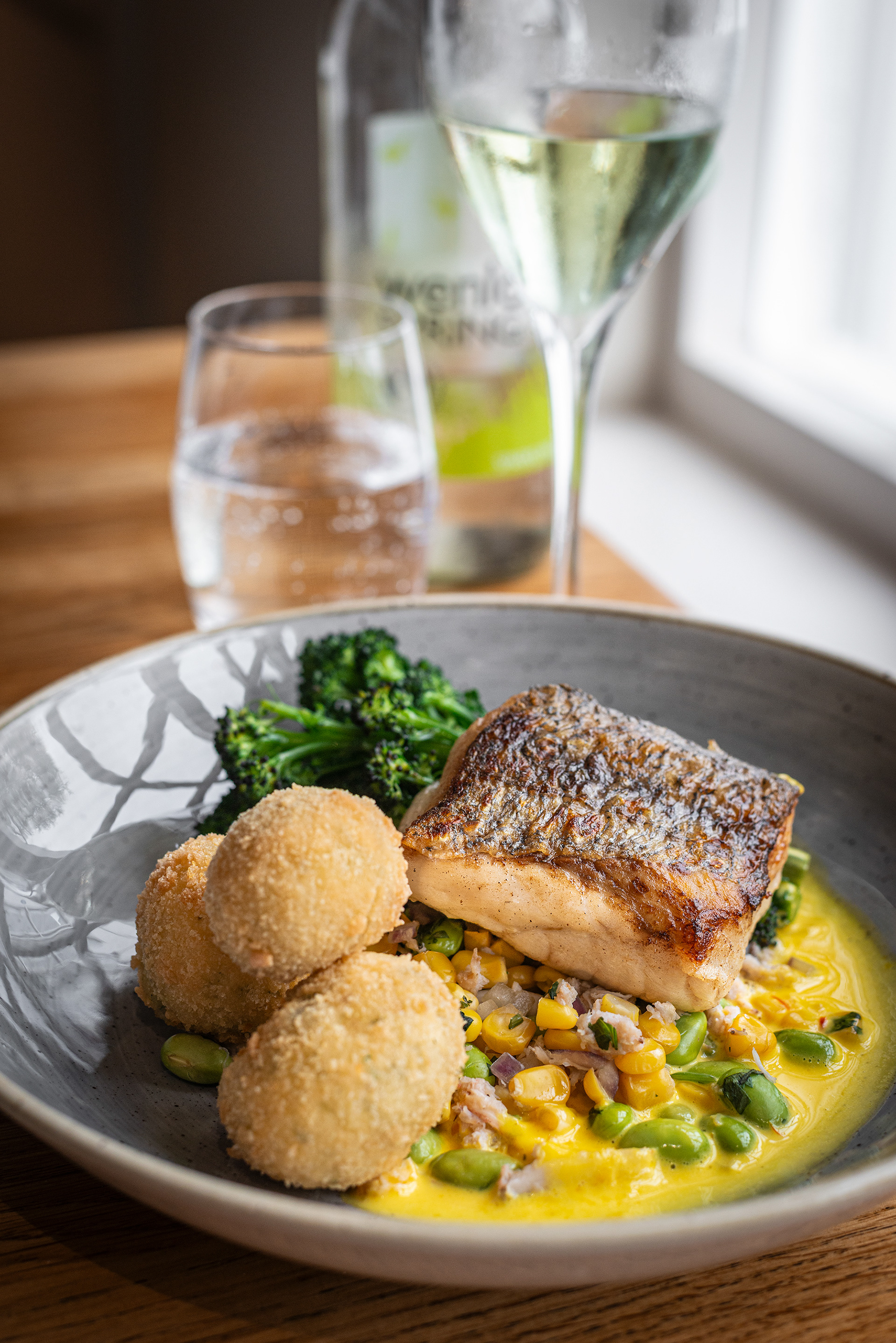 Hake Fillet, Crab & sweetcorn succotash, purple broccoli, potato & dill croquettes, saffron sauce - Clive Arms