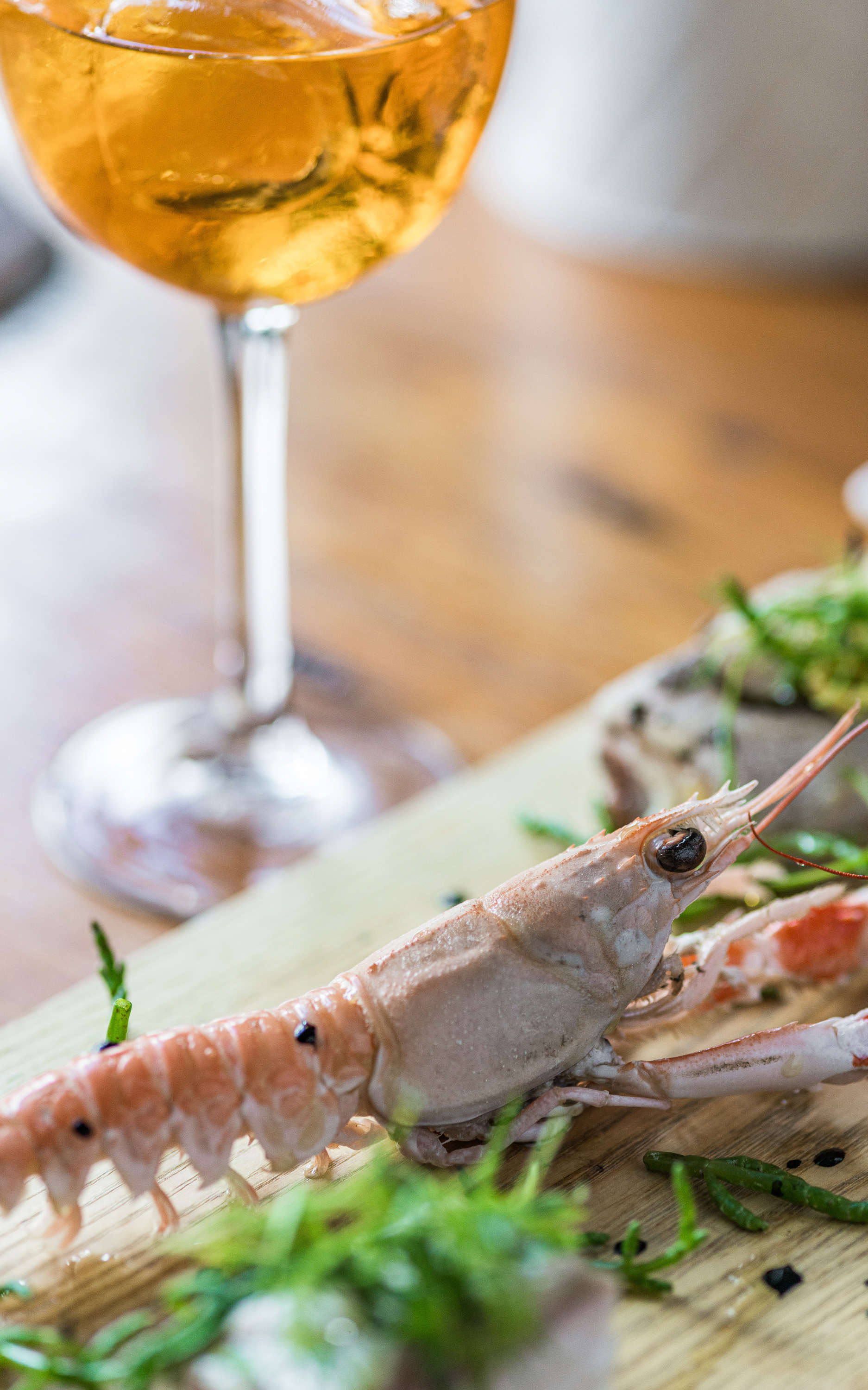 Langoustine marinated in olive oil with slow cooked hake and splashes of cuttlefish ink and samphire for starters at La Locanda restaurant in Gisburn, Lancs
