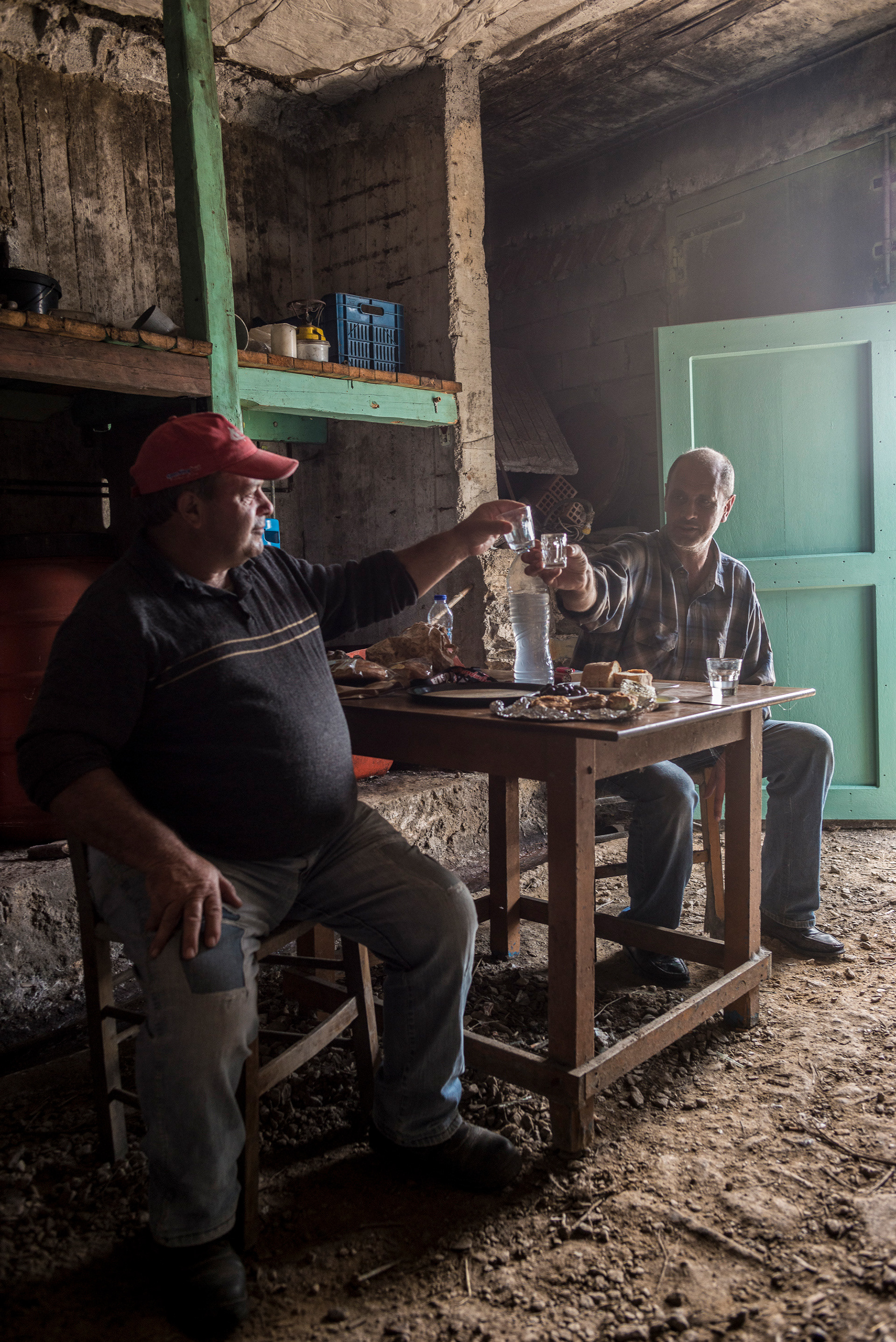 Mr Diamantopoulos celebrating the latest batch of his 80% proof Raki at his underground distillery, Tinos