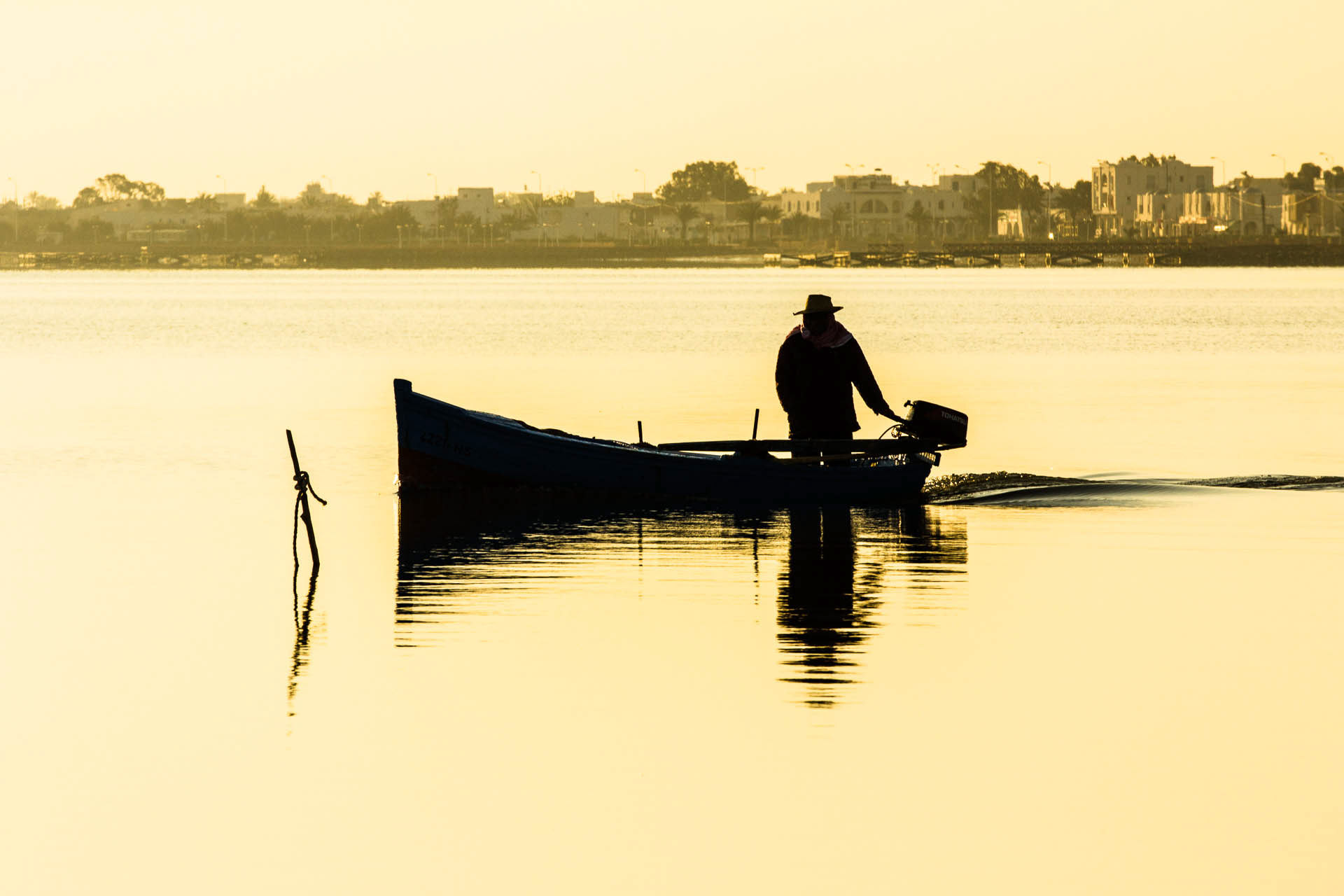 Fisherman at sunrise, Houmt Souk Port, Djerba Island, Tunisia