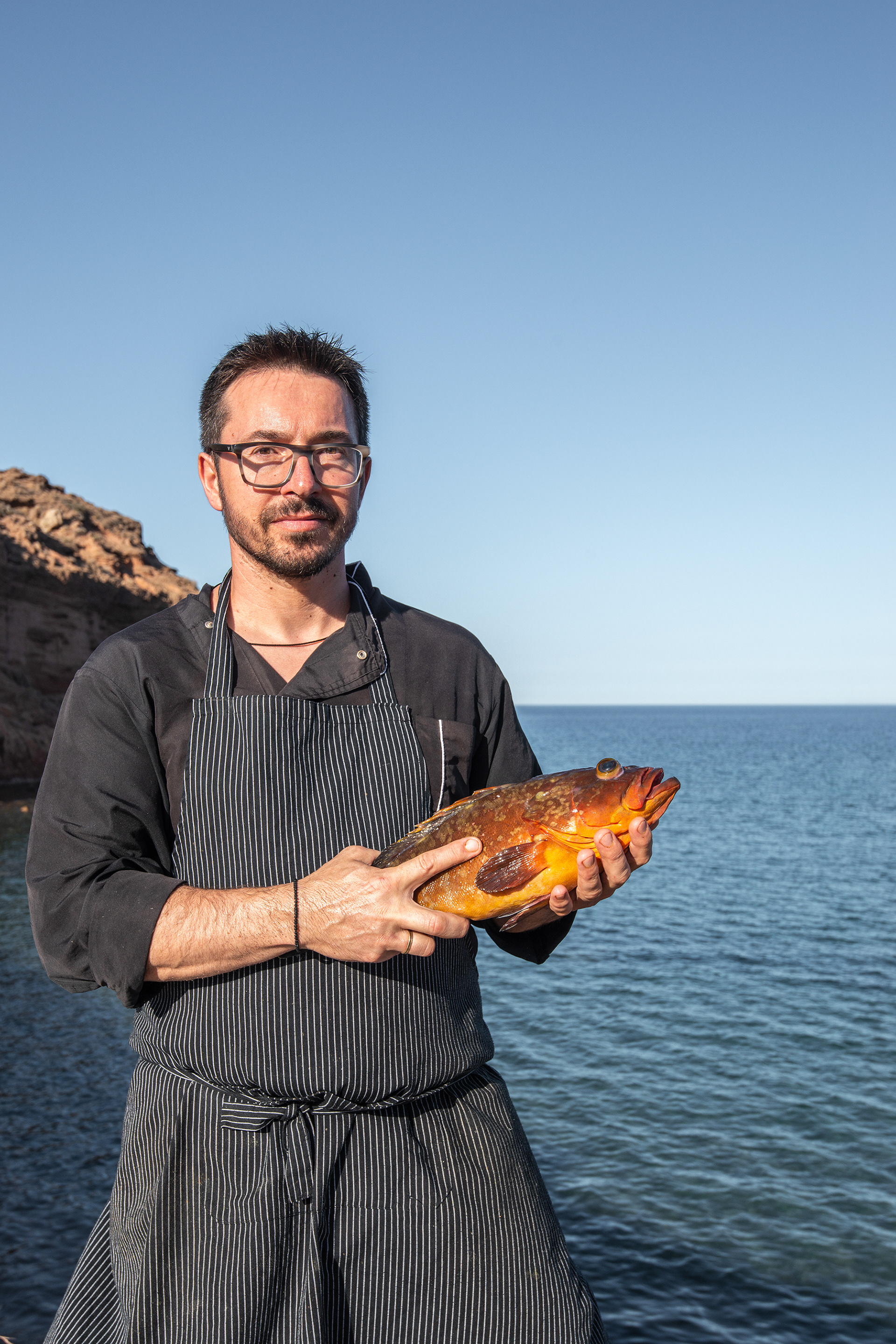 Giorgos Xipolitakis Chef with Grouper - Hiona Restaurant - Palekastro fishing village