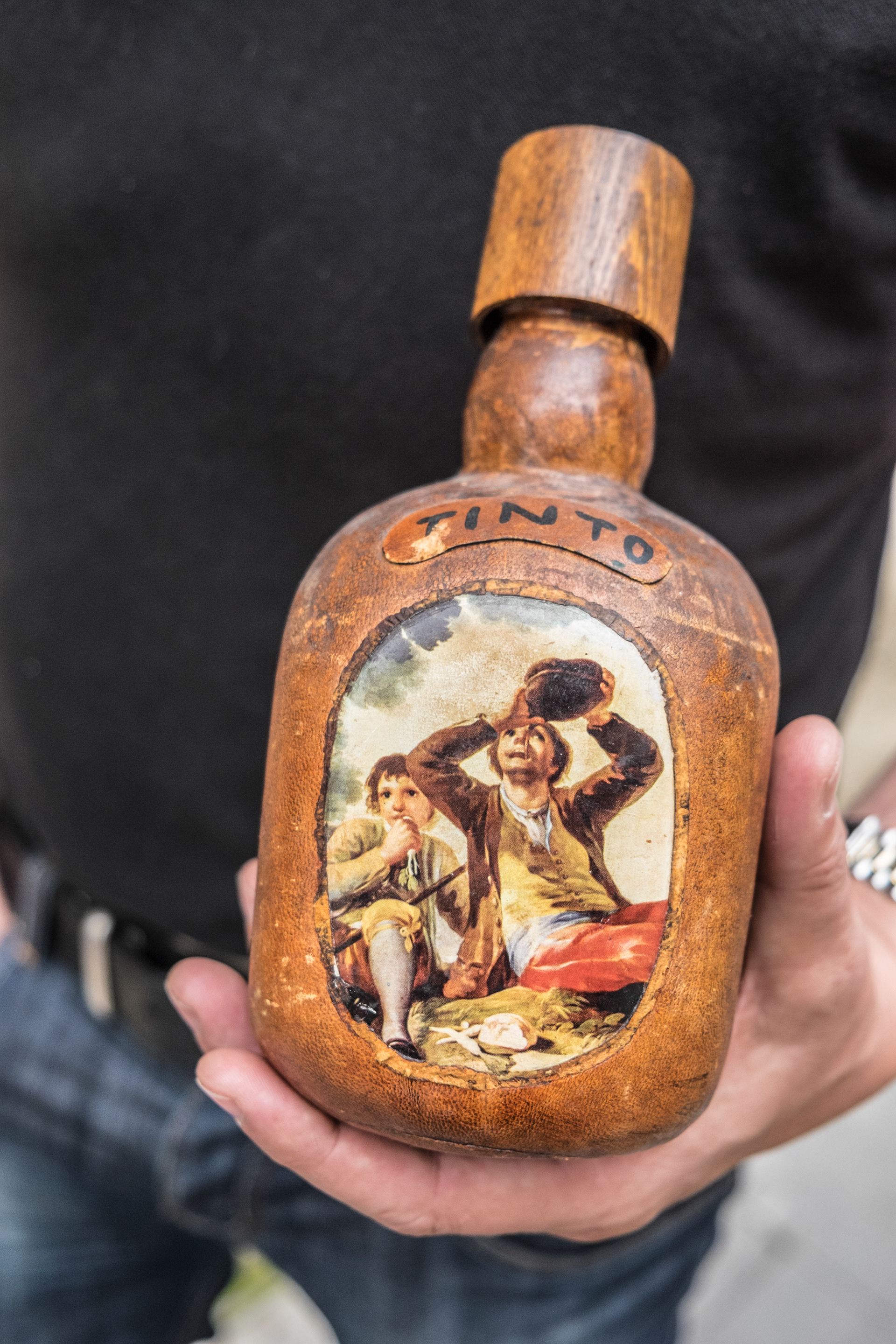 Old wood covered wine bottle at Calado wine cellar - el educadoren vinos - Lograno