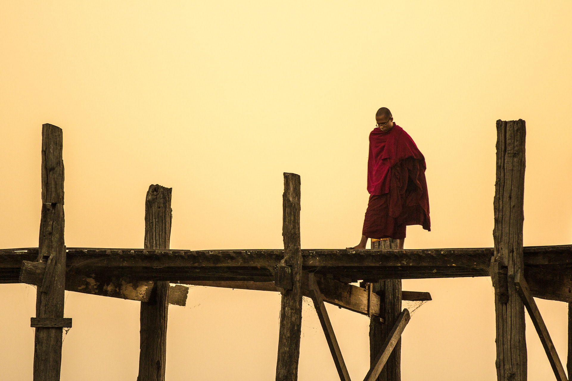 Pondering eternity? Or just admiring the view? You will find lots of Buddhist monks at sunset on U Bein Bridge - Near Mandalay - Burma