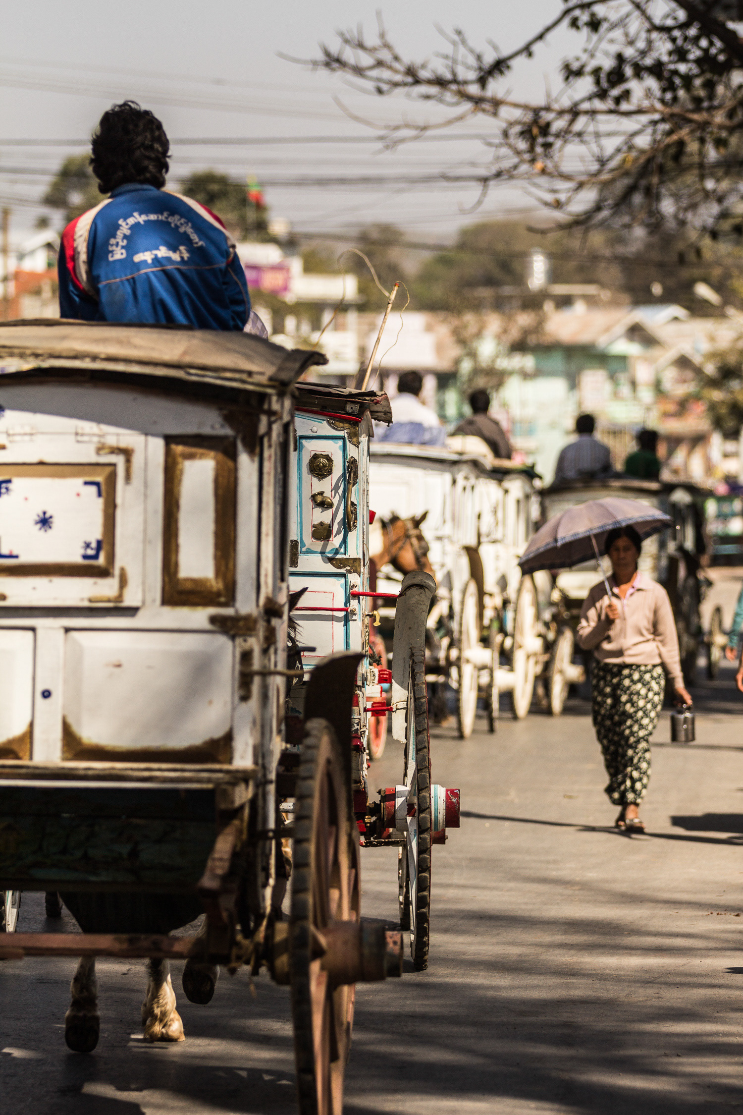 Not just for tourists! These traditional Victorian miniature horse drawn stagecoaches (used as taxis) wait for the locals outside the market in Pyin U Lwin - Burma.