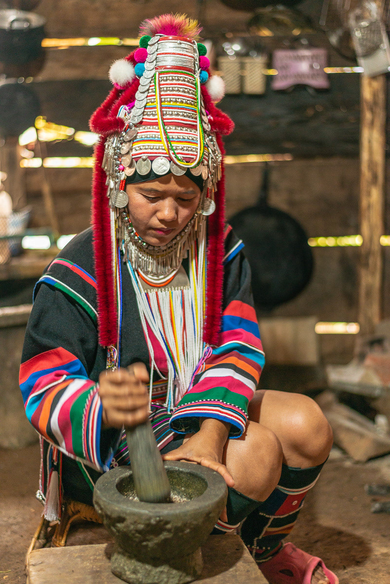 Village life... Pounding chilli paste. The kitchen is in a separate part of the home from the living and sleeping areas